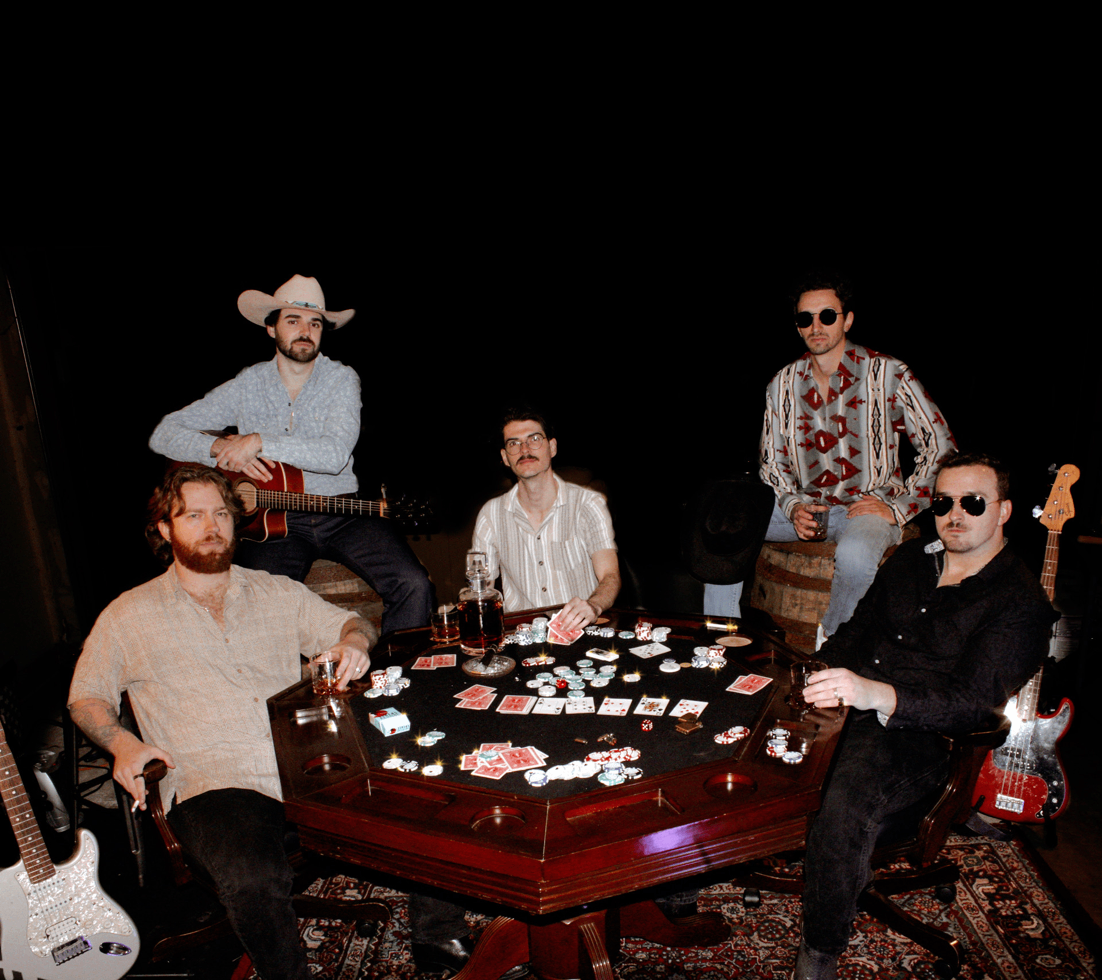 a group of men sitting around a table playing cards