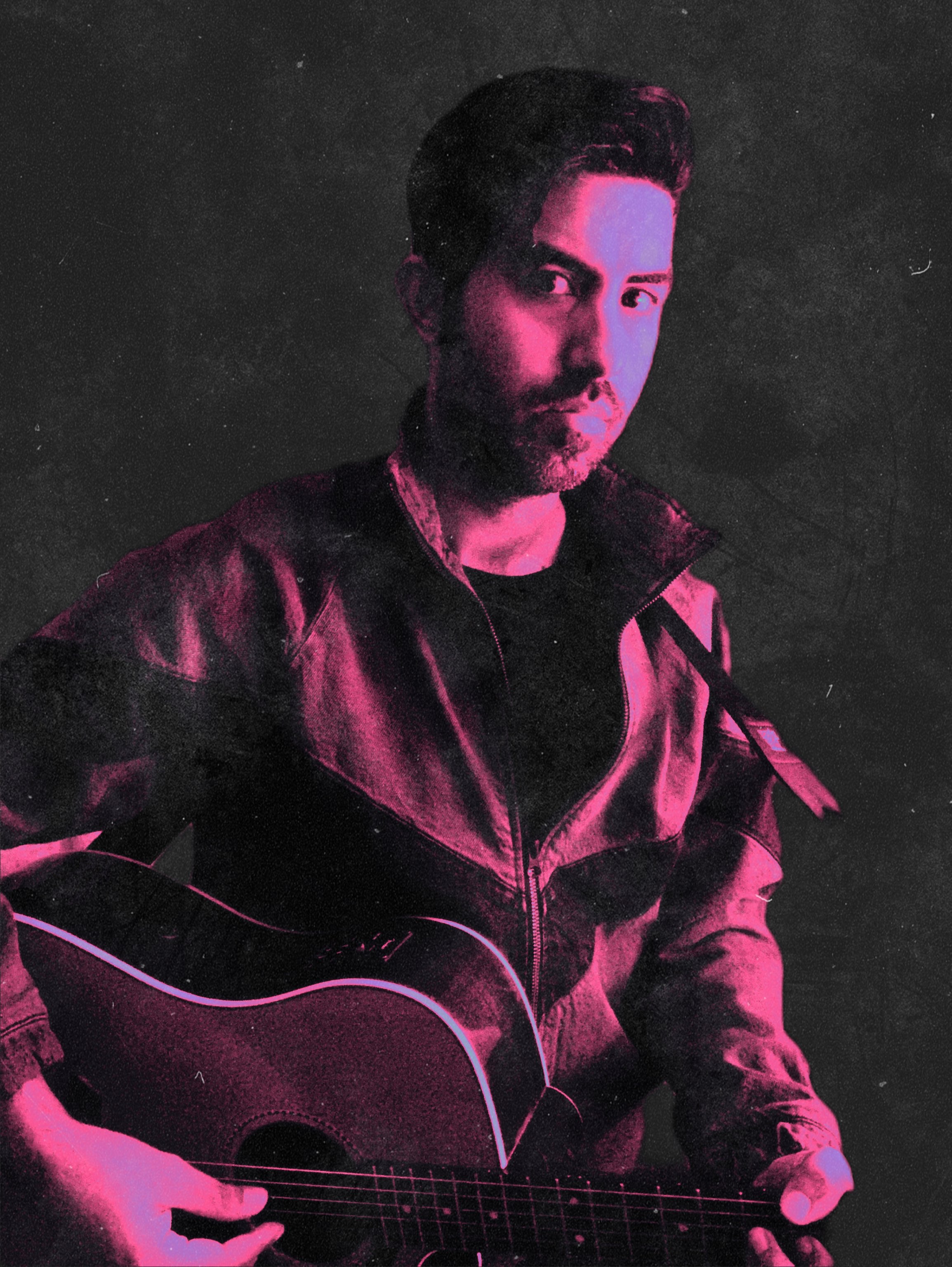 a man holding an acoustic guitar in front of a pink background