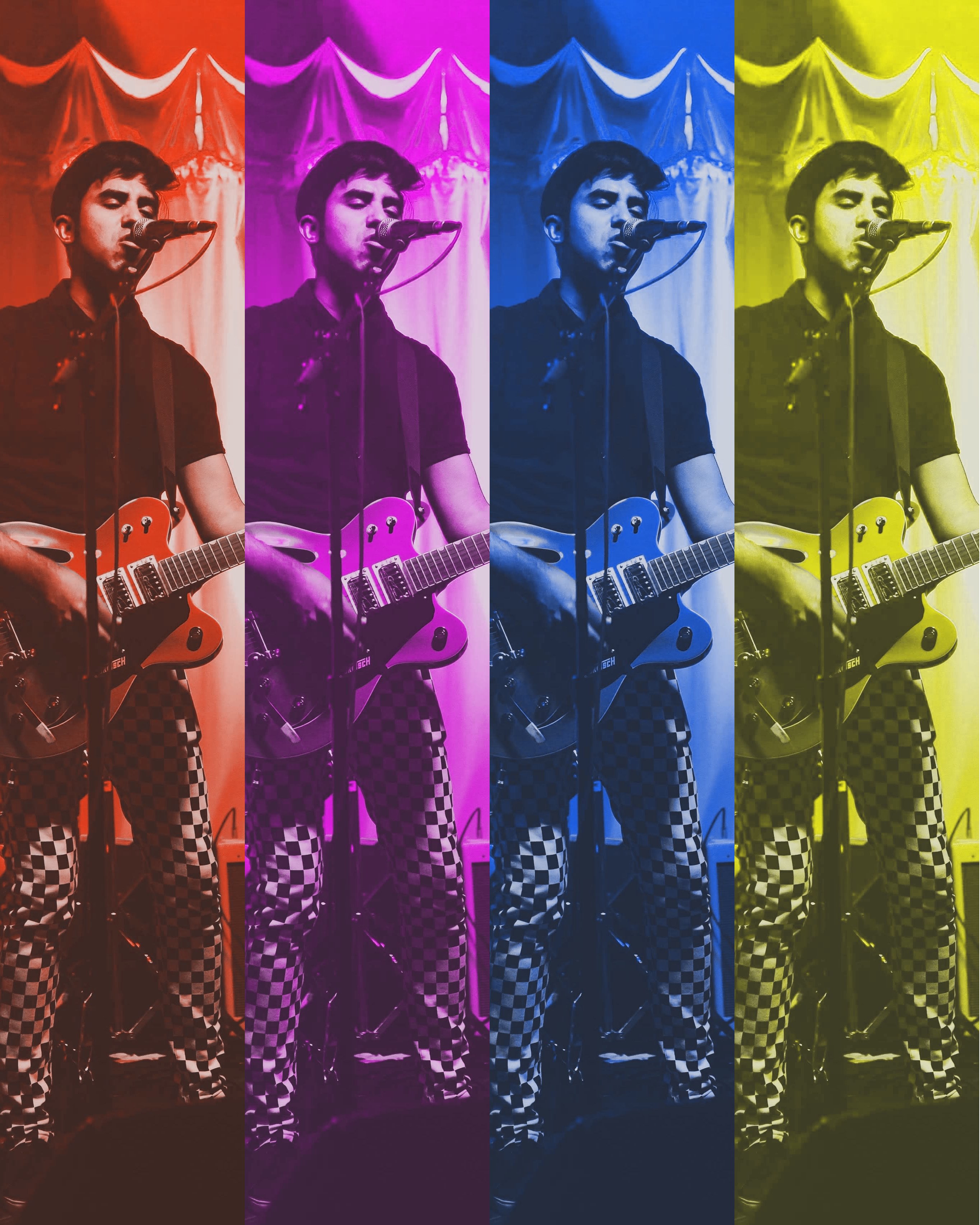 a man with a guitar in front of a microphone