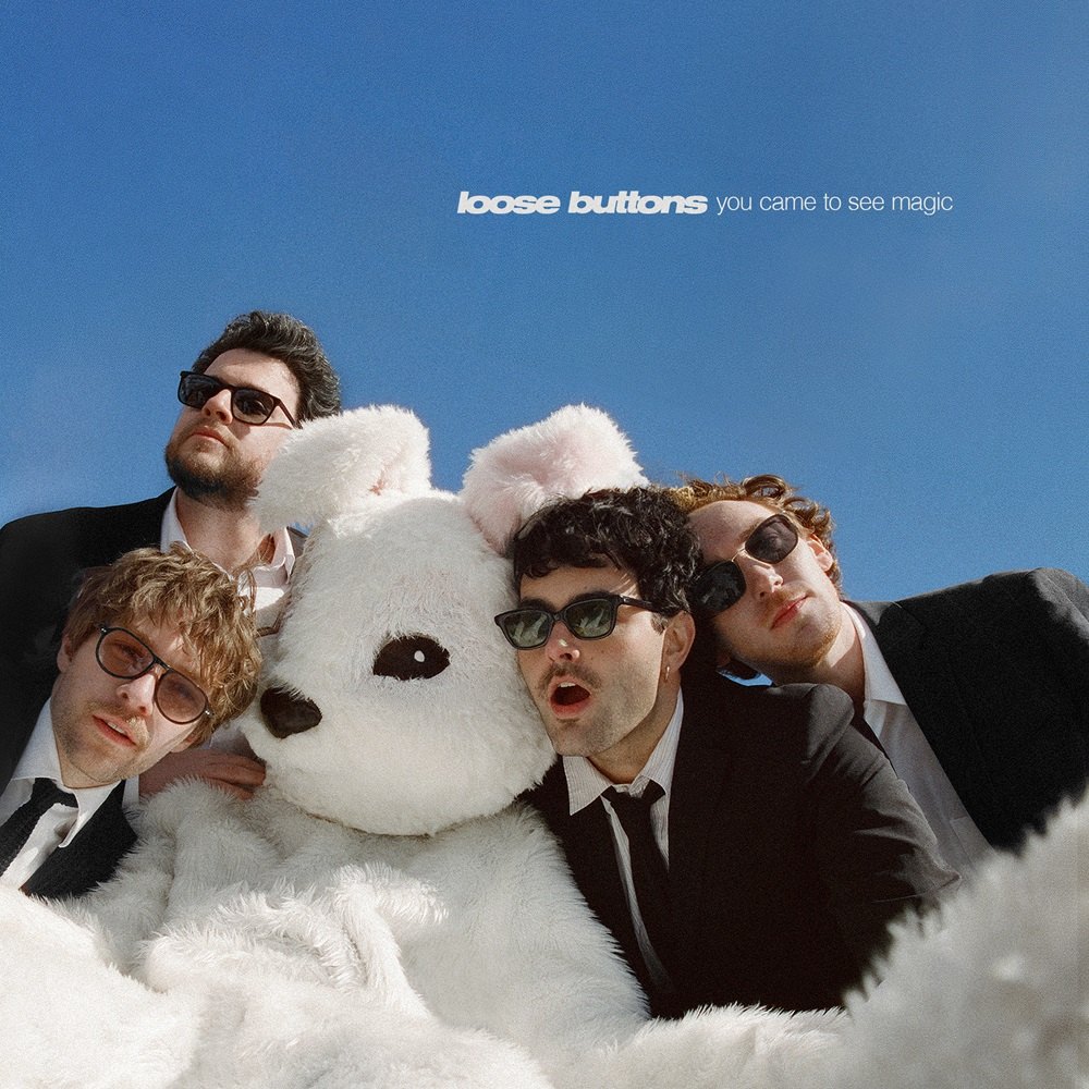 Loose Buttons - Come To Brazil: a group of men posing with a white teddy bear
