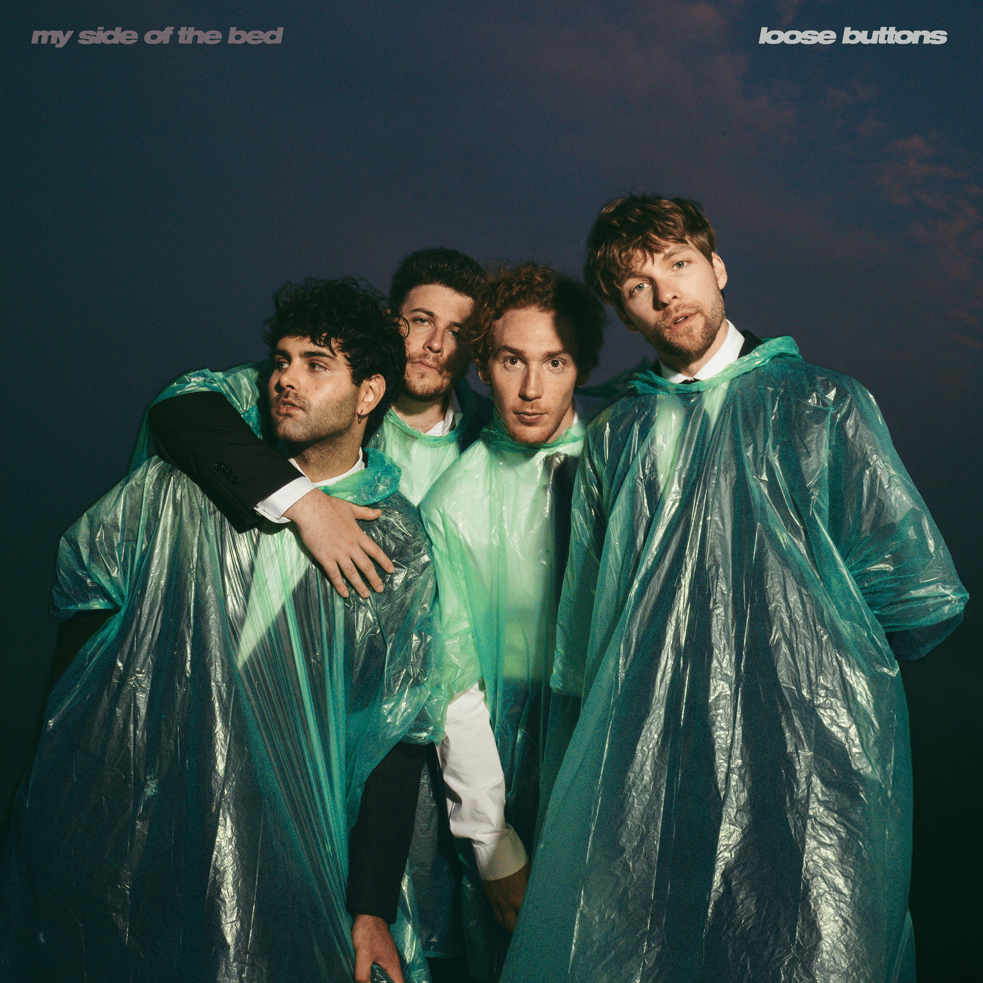 a group of men in raincoats posing for a picture