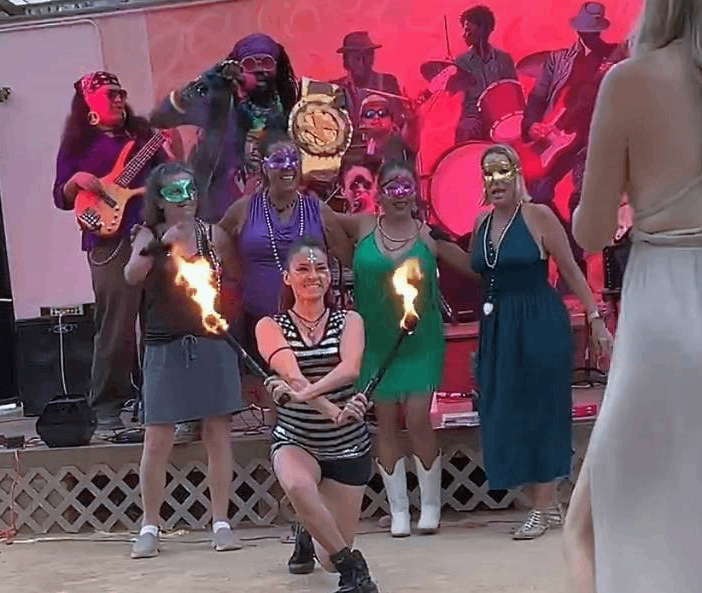 a group of people standing on a stage with fire torches