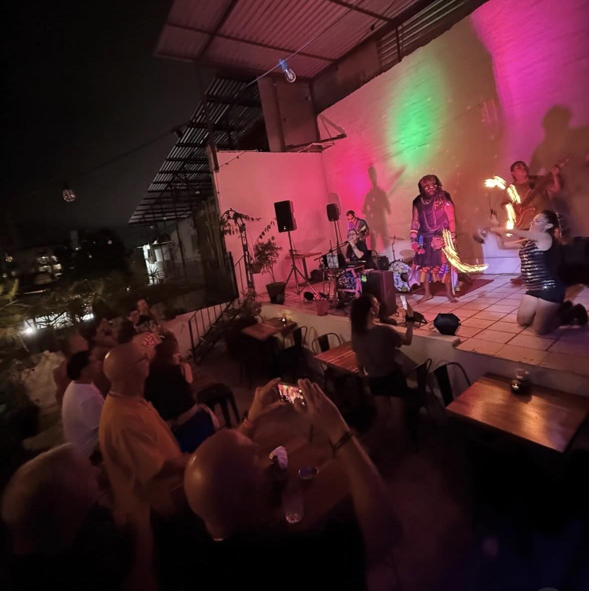 a group of people watching a performance on a rooftop