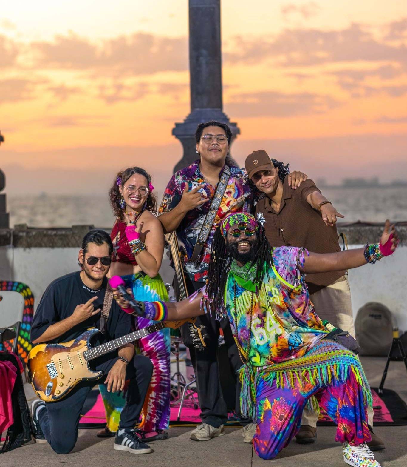 a group of people posing for a photo at sunset