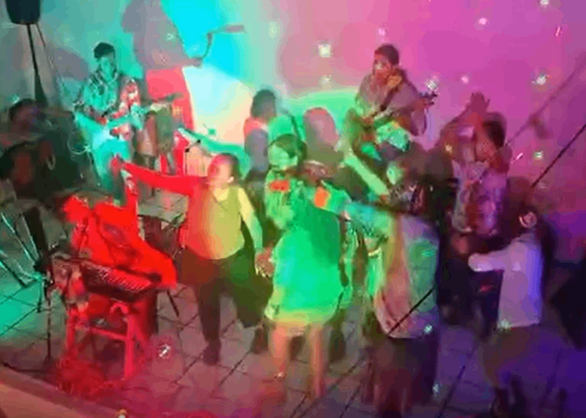 a group of people in a room with colorful lights