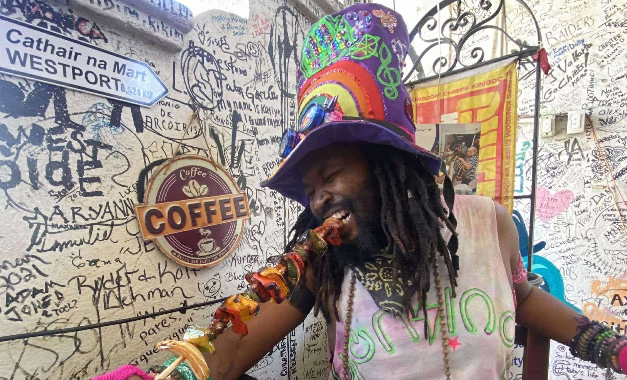 a man in a hat with a pipe in his hand