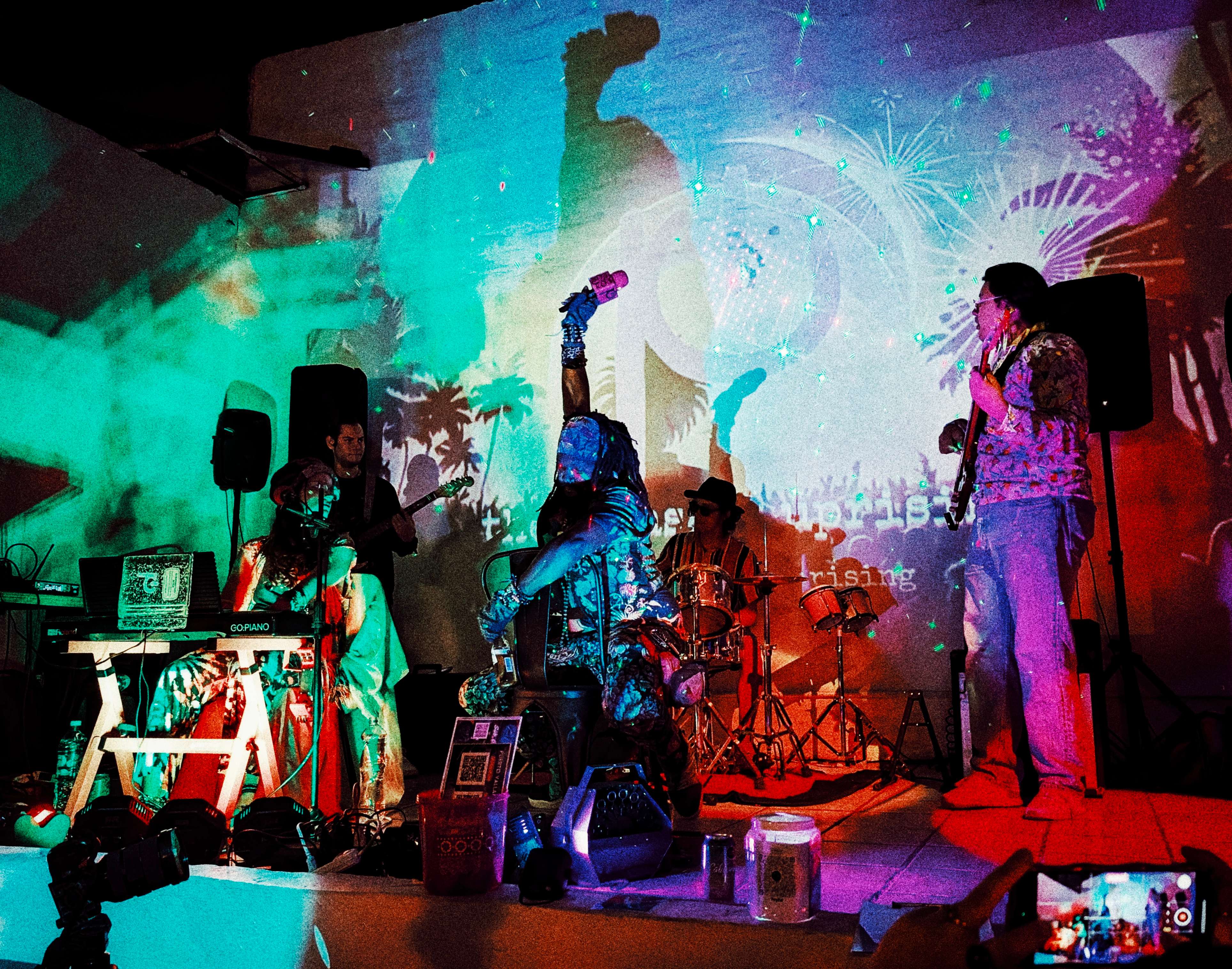 the pleasant uprising tip jar: a group of people on a stage