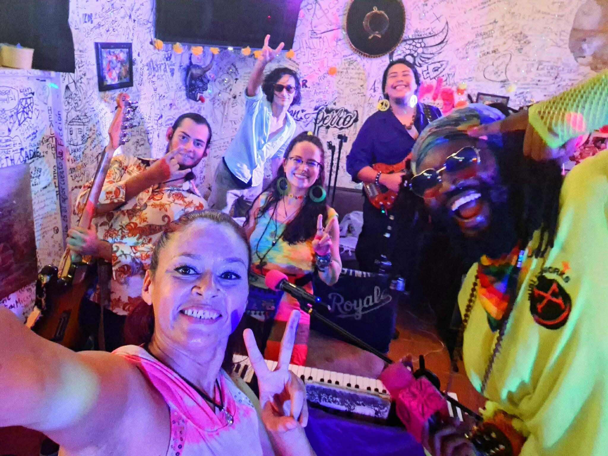 the pleasant uprising tip jar: a group of people posing for a photo in a bar