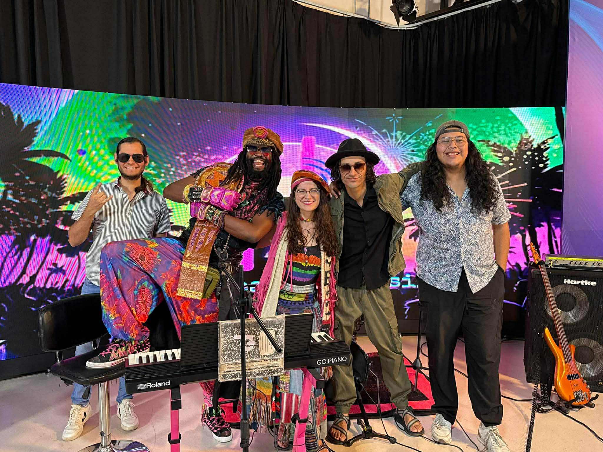 a group of people posing for a picture on a stage