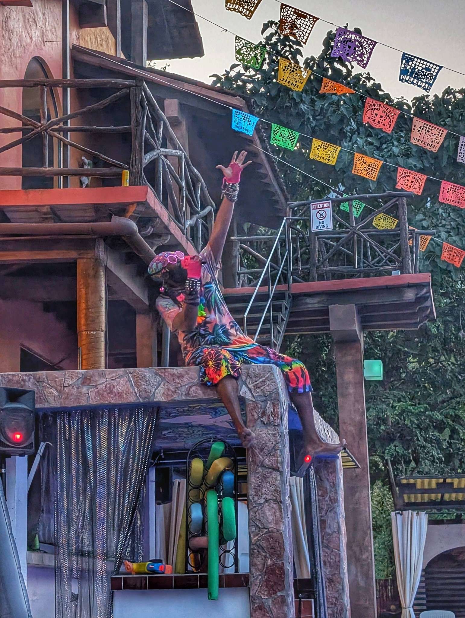 a person is sitting on top of a building with colorful flags