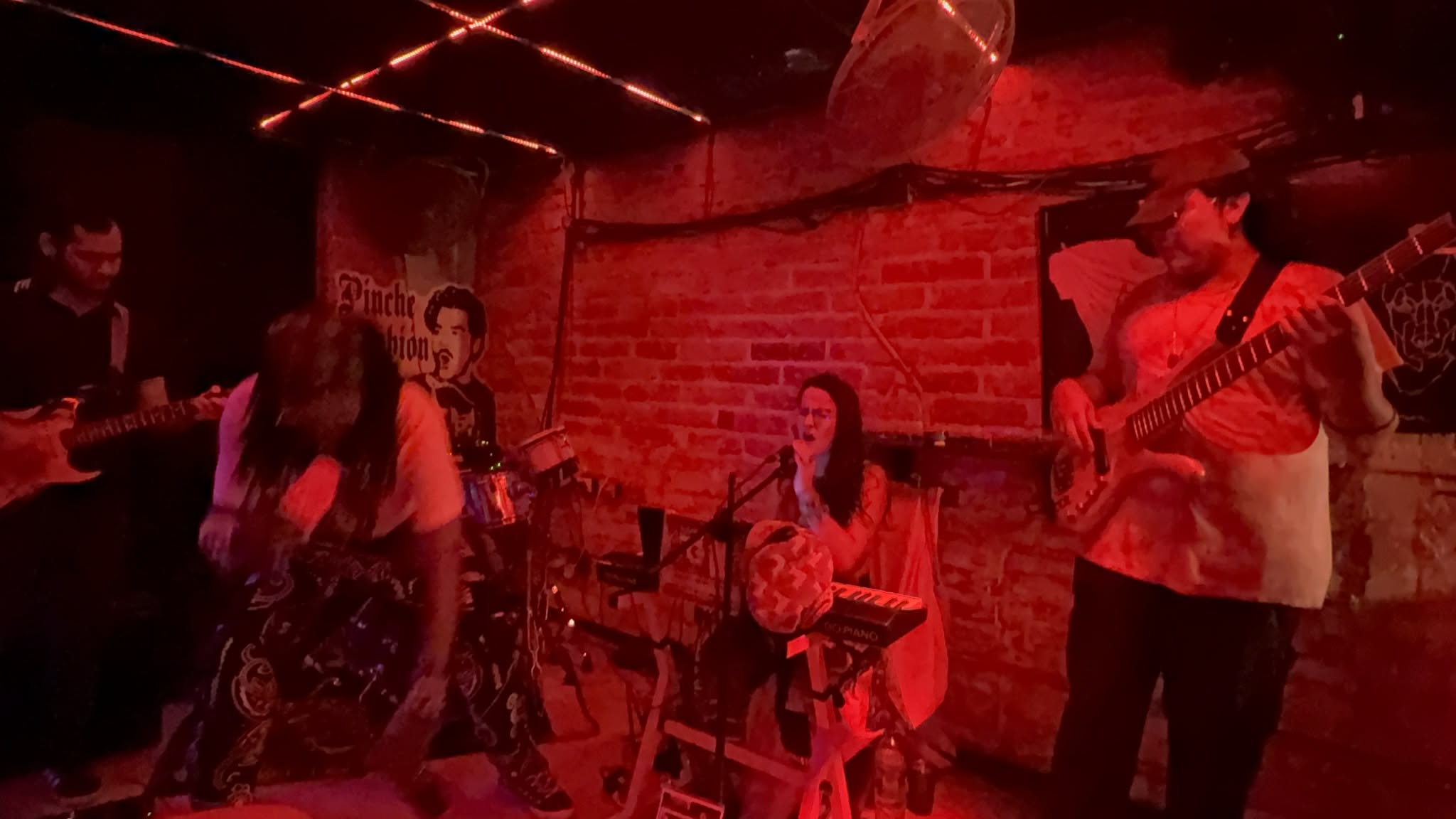 a group of people playing music in a dark room