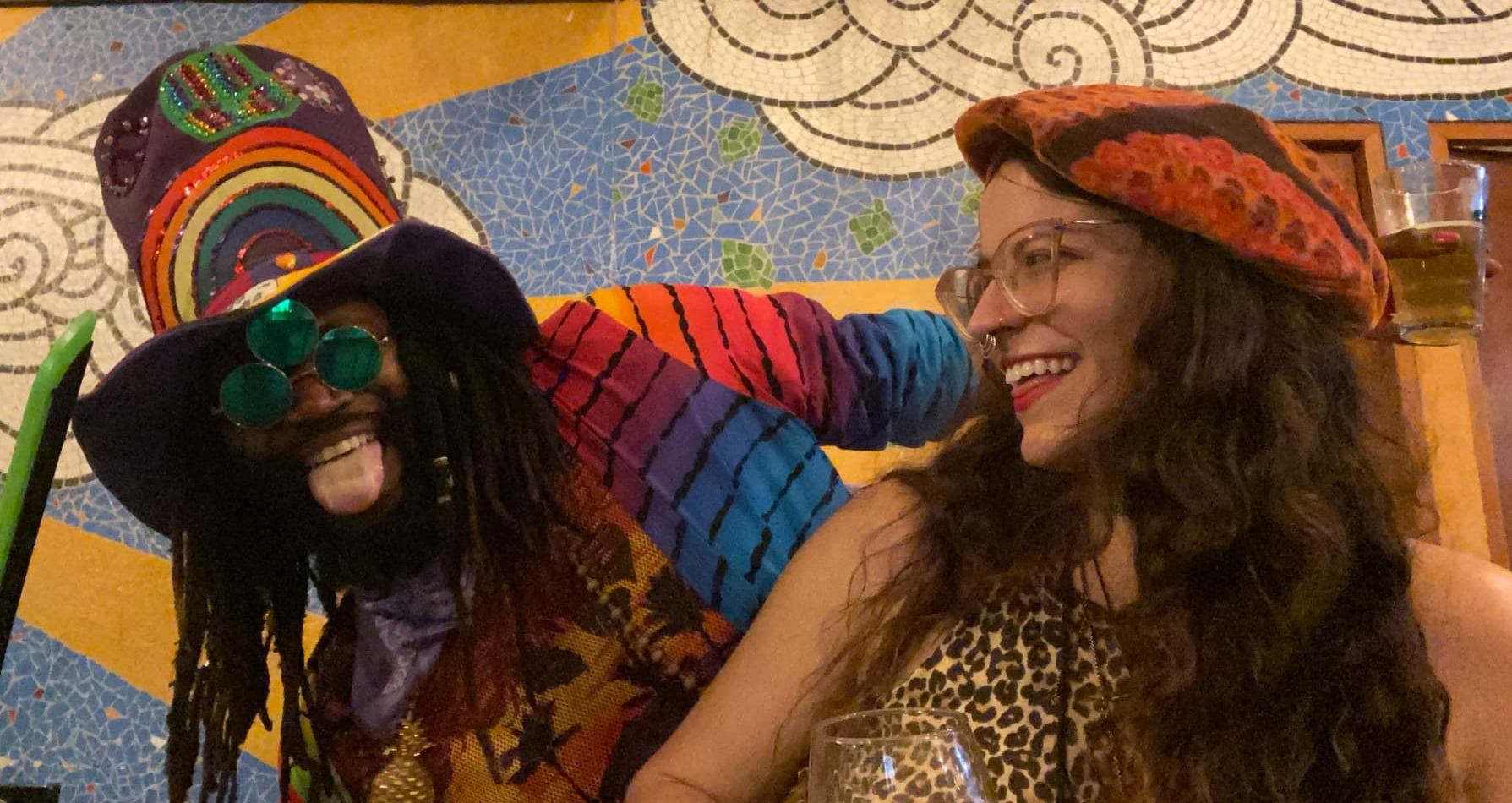 a man and a woman smiling at each other at a bar