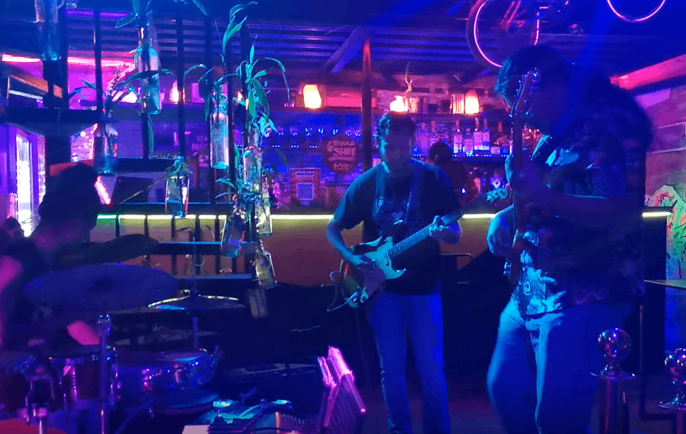 a group of people playing music in a bar