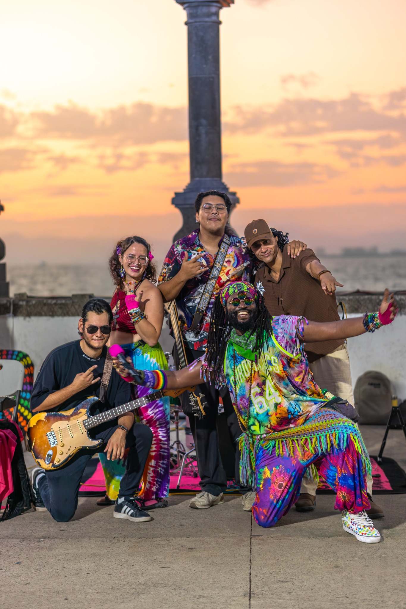 a group of people posing for a photo at sunset