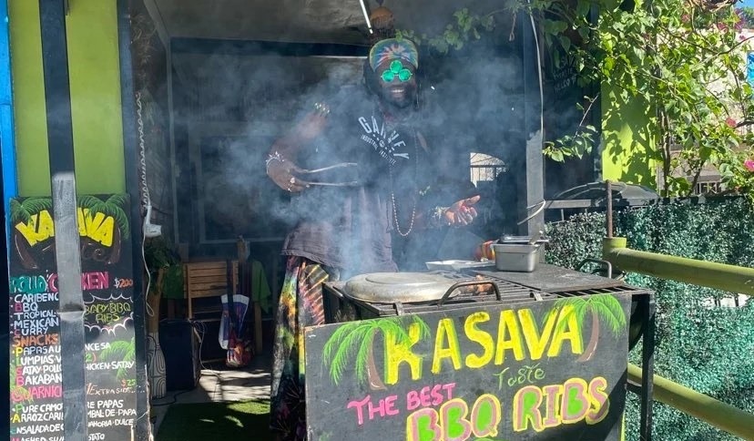 a man in a mask is smoking a cigarette outside of a restaurant