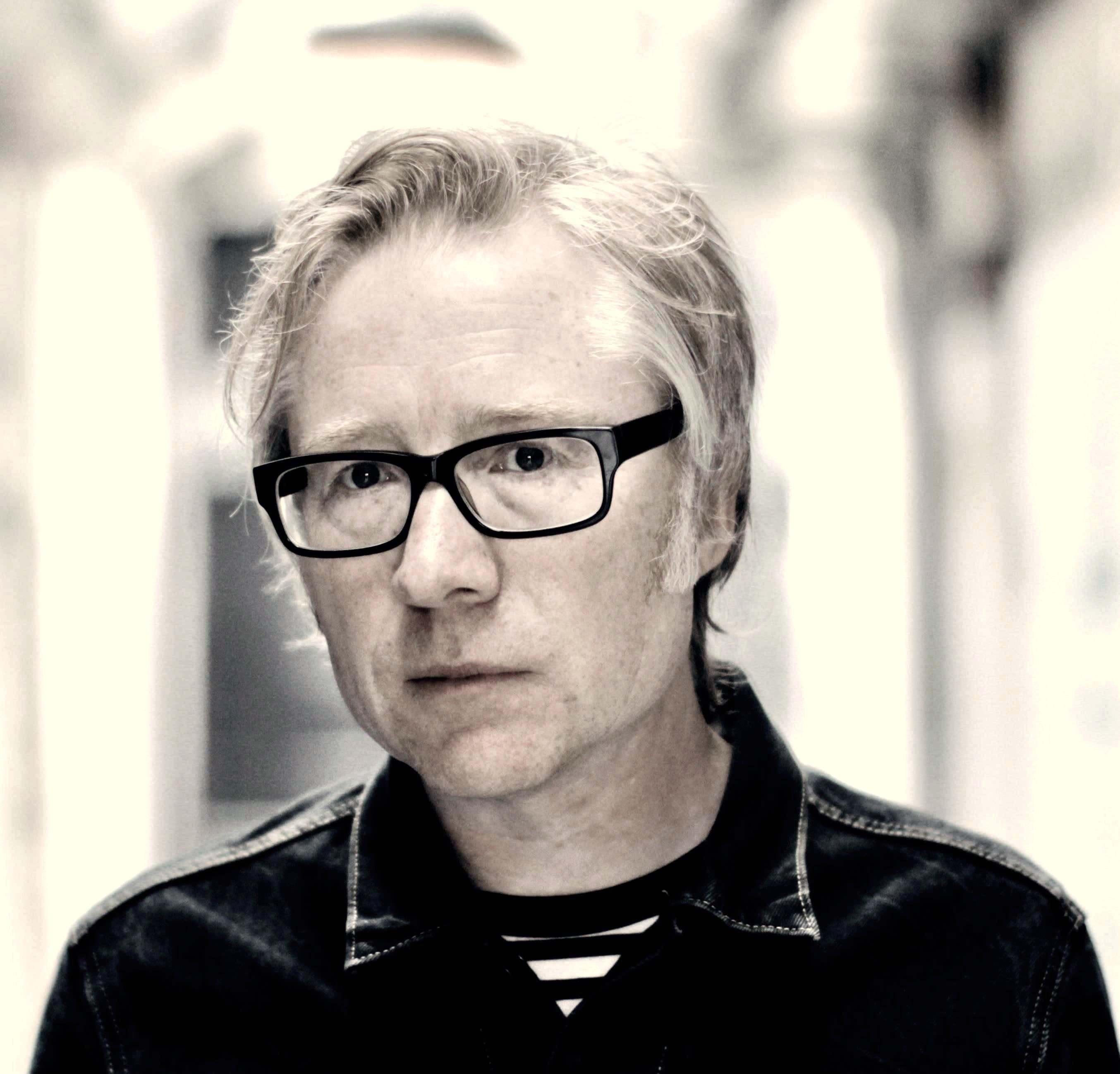 a black and white photo of a man in glasses