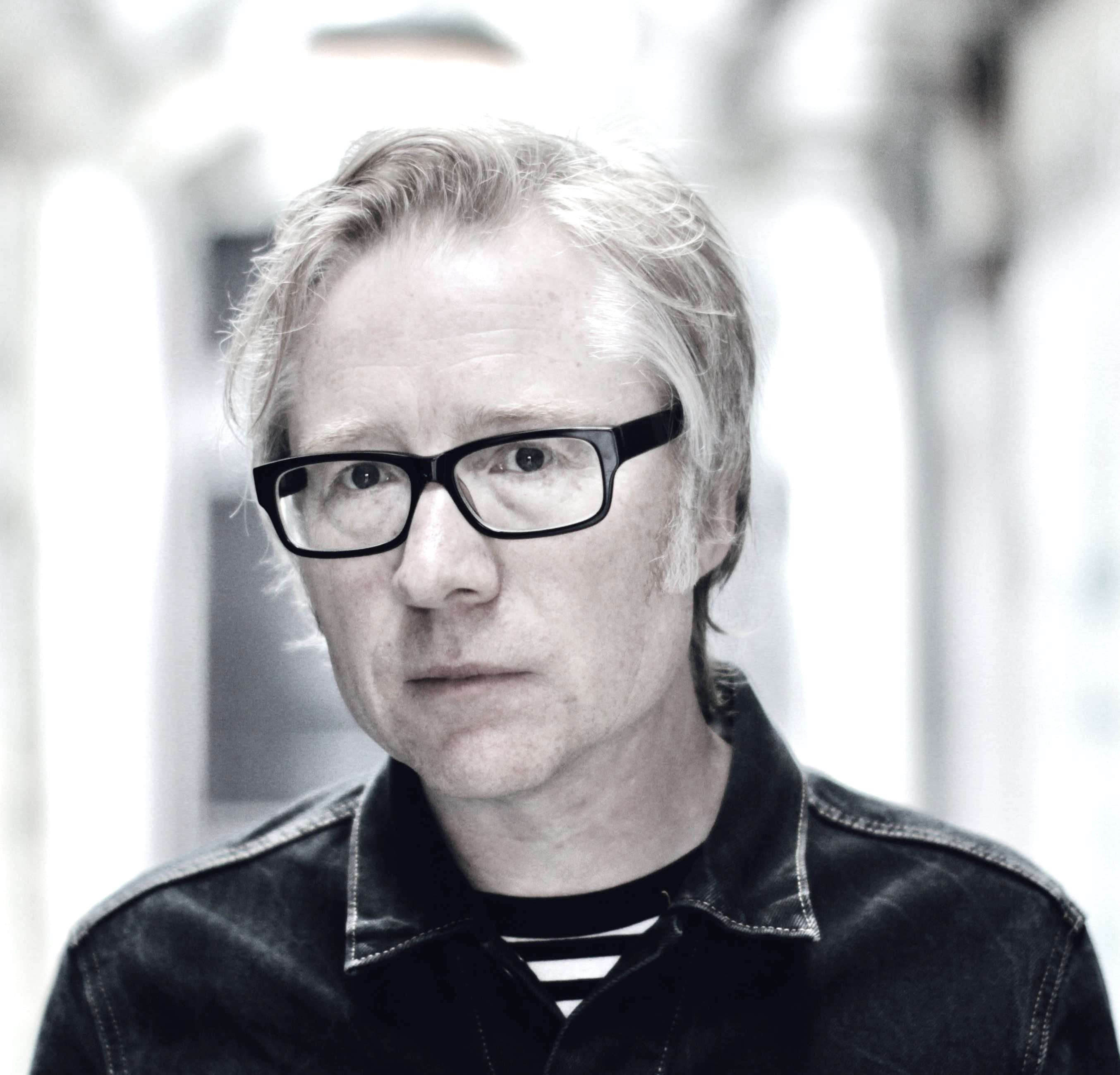 a man wearing glasses and a black shirt