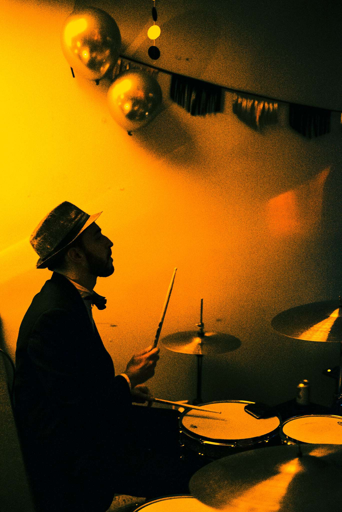a man is playing drums in a room