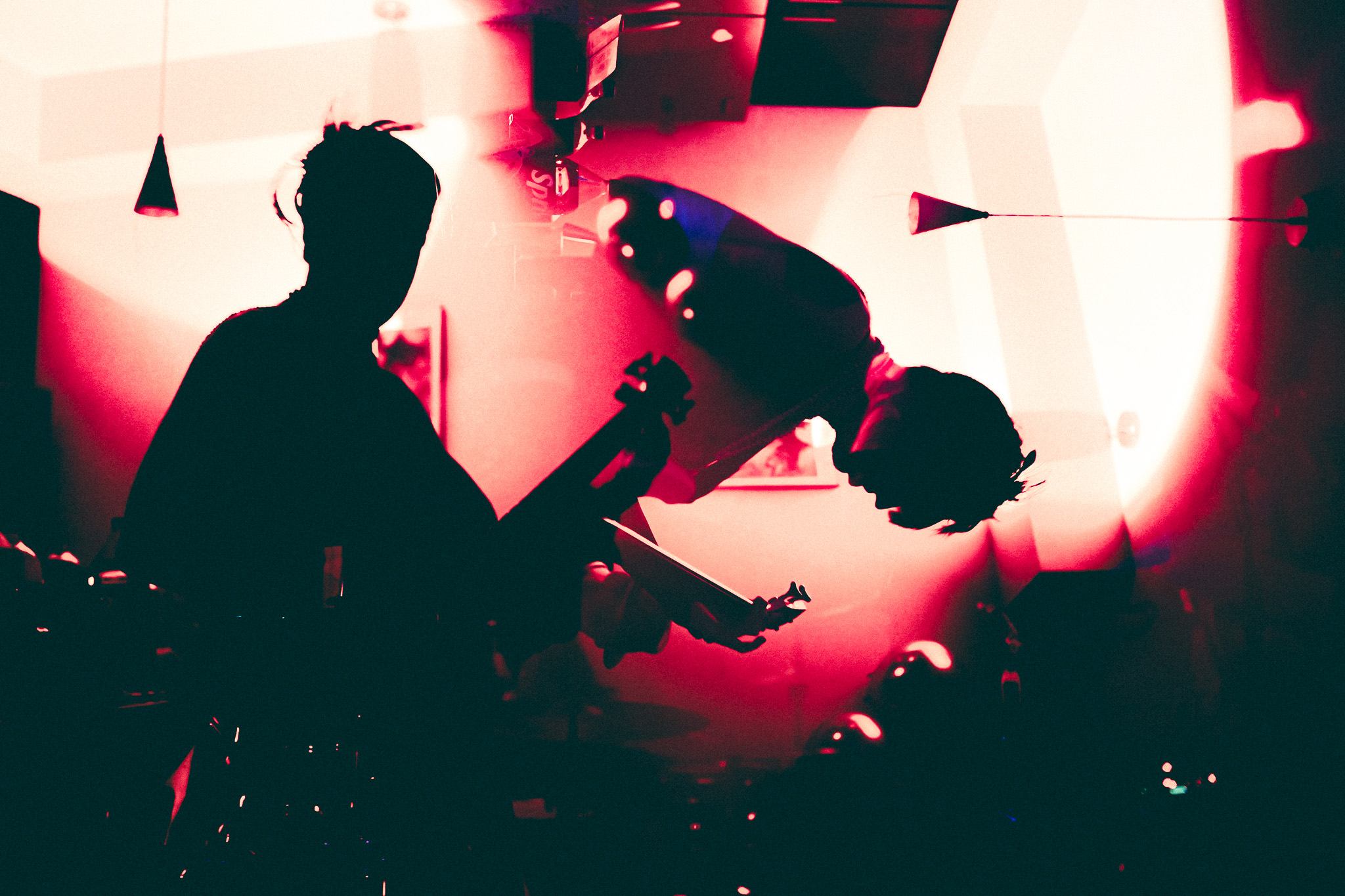 a man is playing a guitar in a dark room