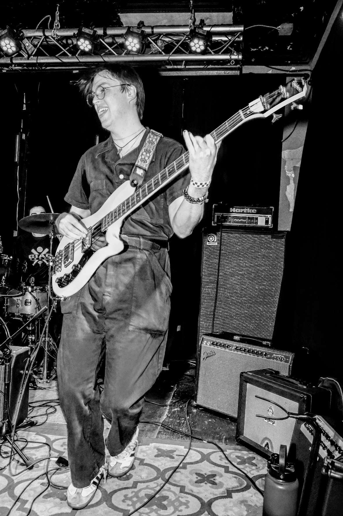 a black and white photo of a man playing a guitar