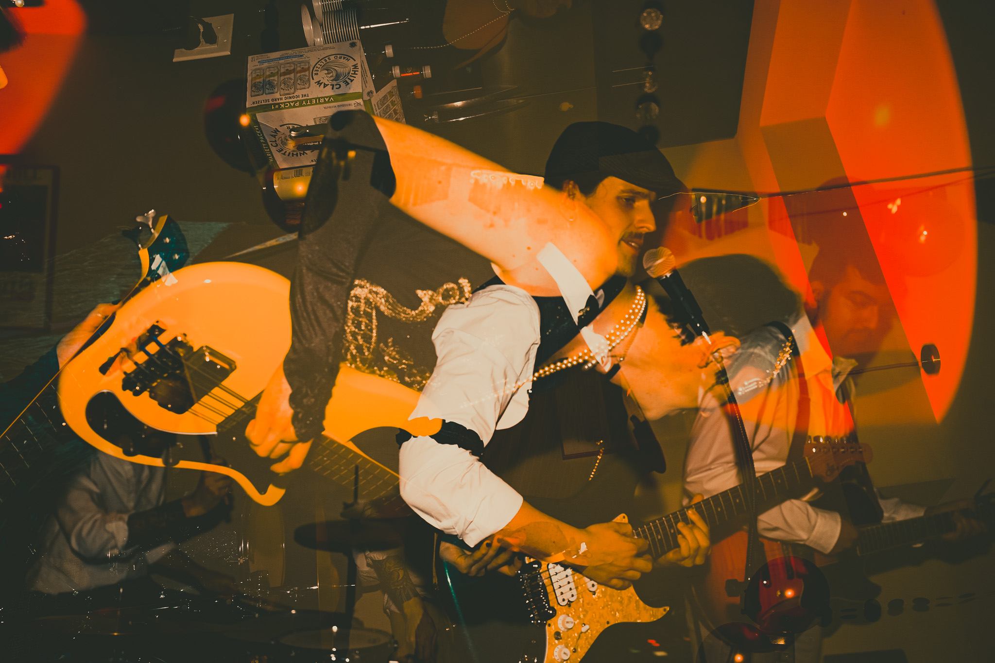 a group of people playing guitars in a bar