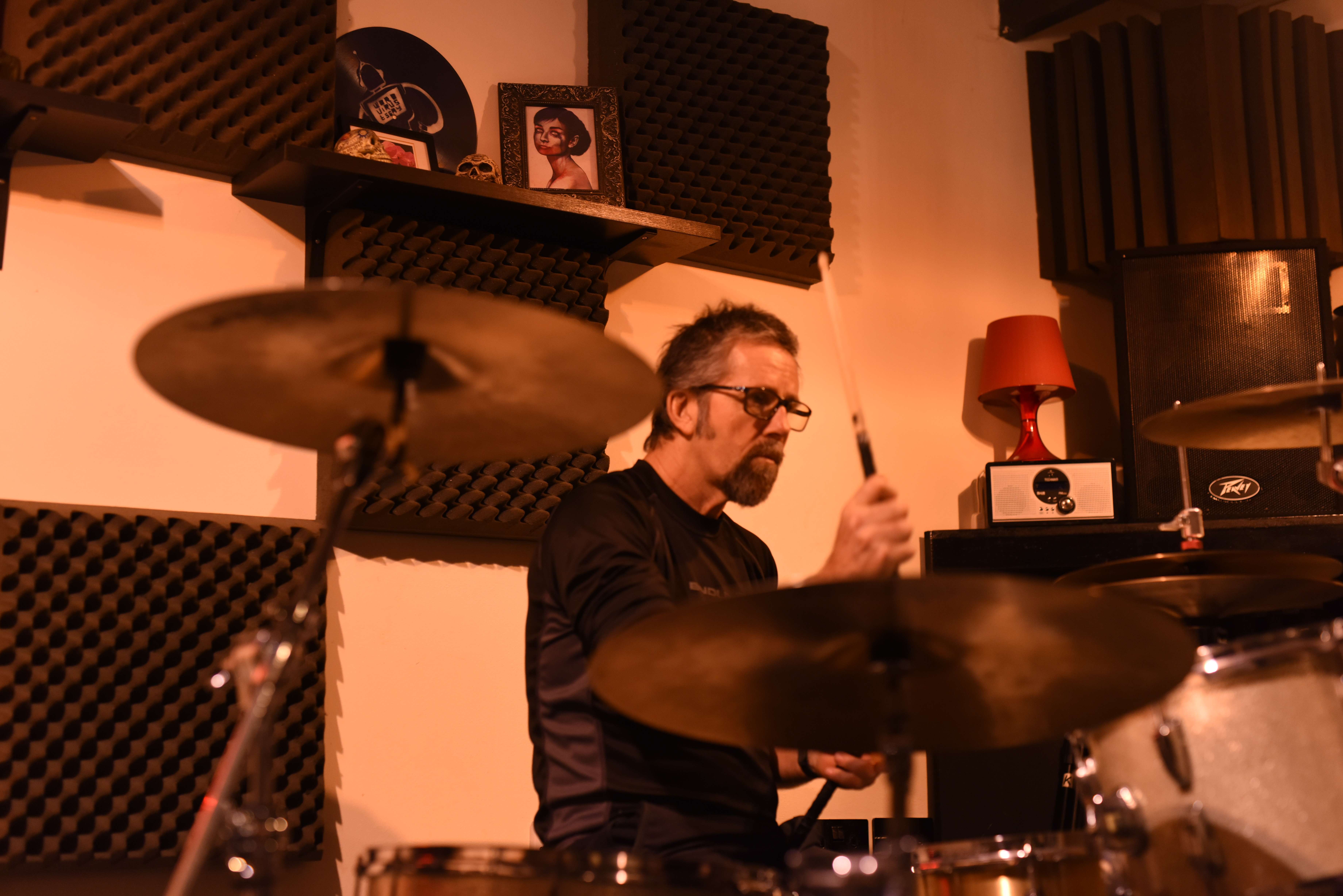 a man playing drums in a recording studio