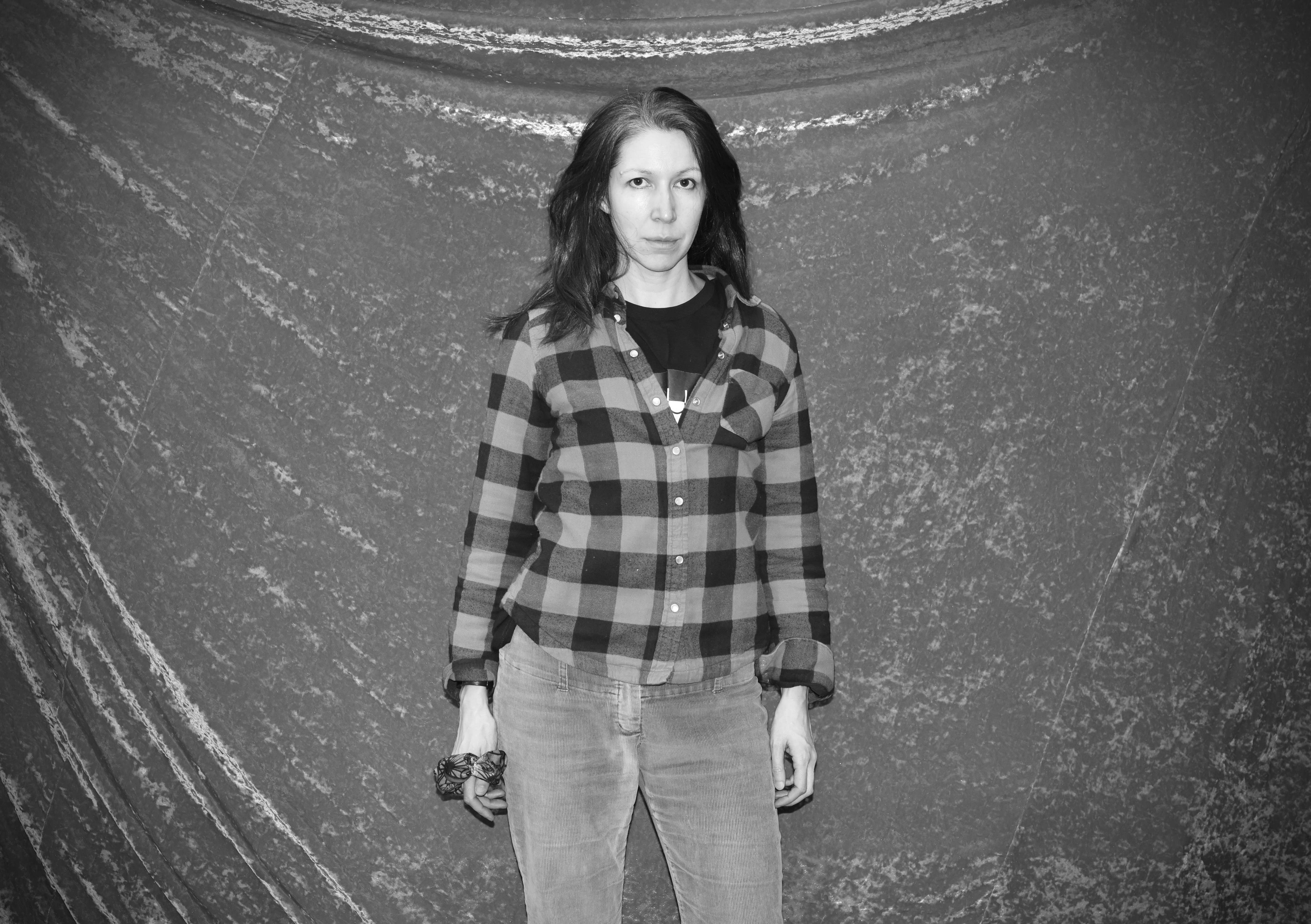 a black and white photo of a woman in a plaid shirt