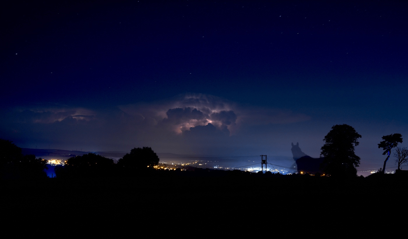 CRITTER CABAL - Denim & Paisley: a night sky with clouds over a hill