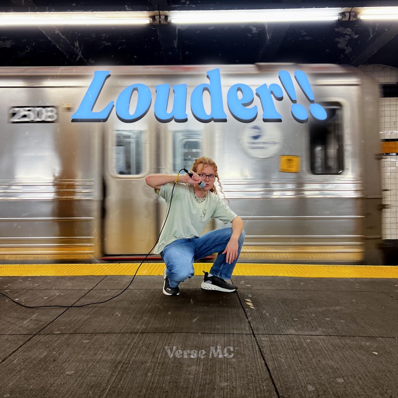 a man crouching in front of a subway train