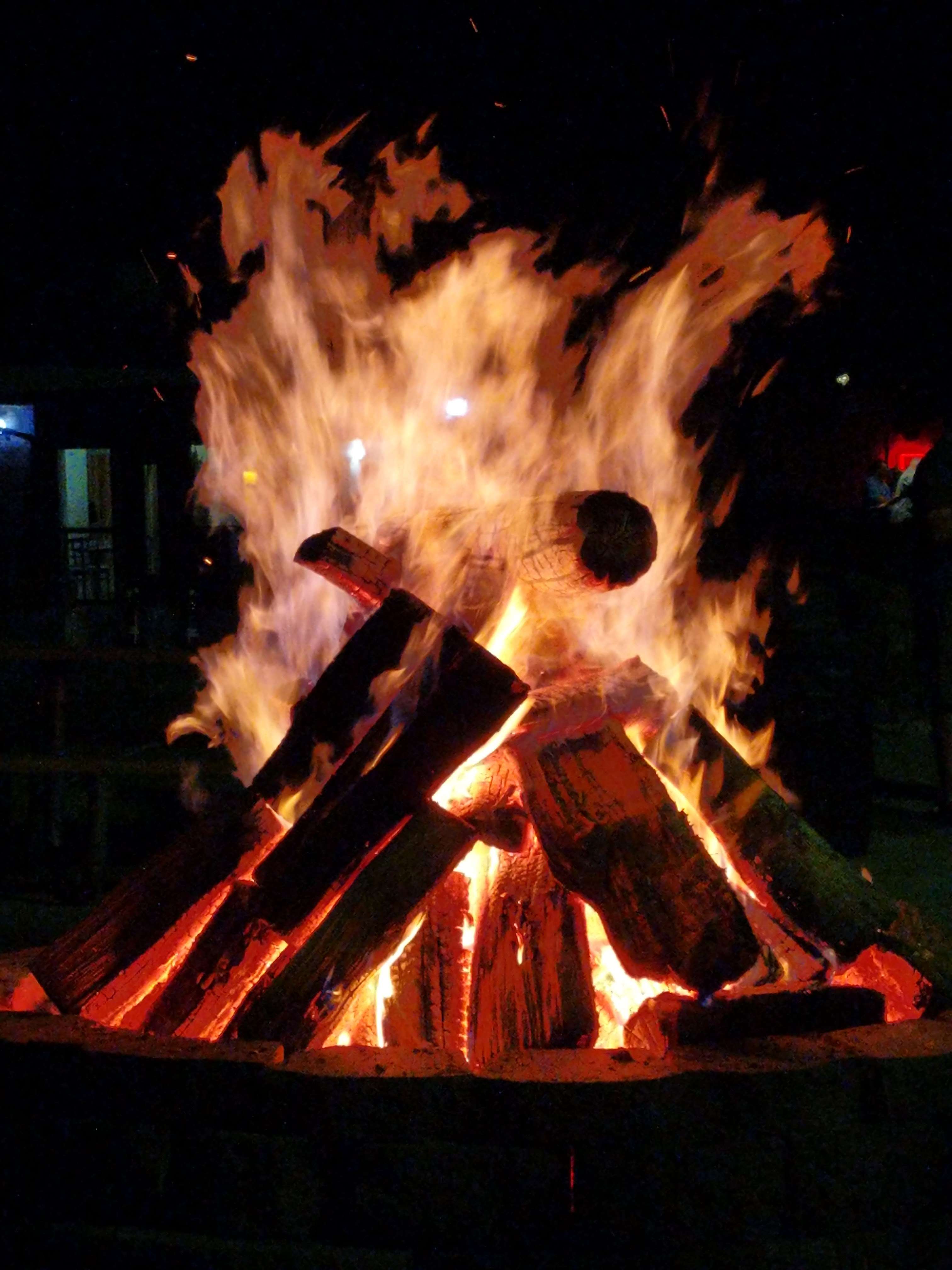 a fire burning in a pit at night