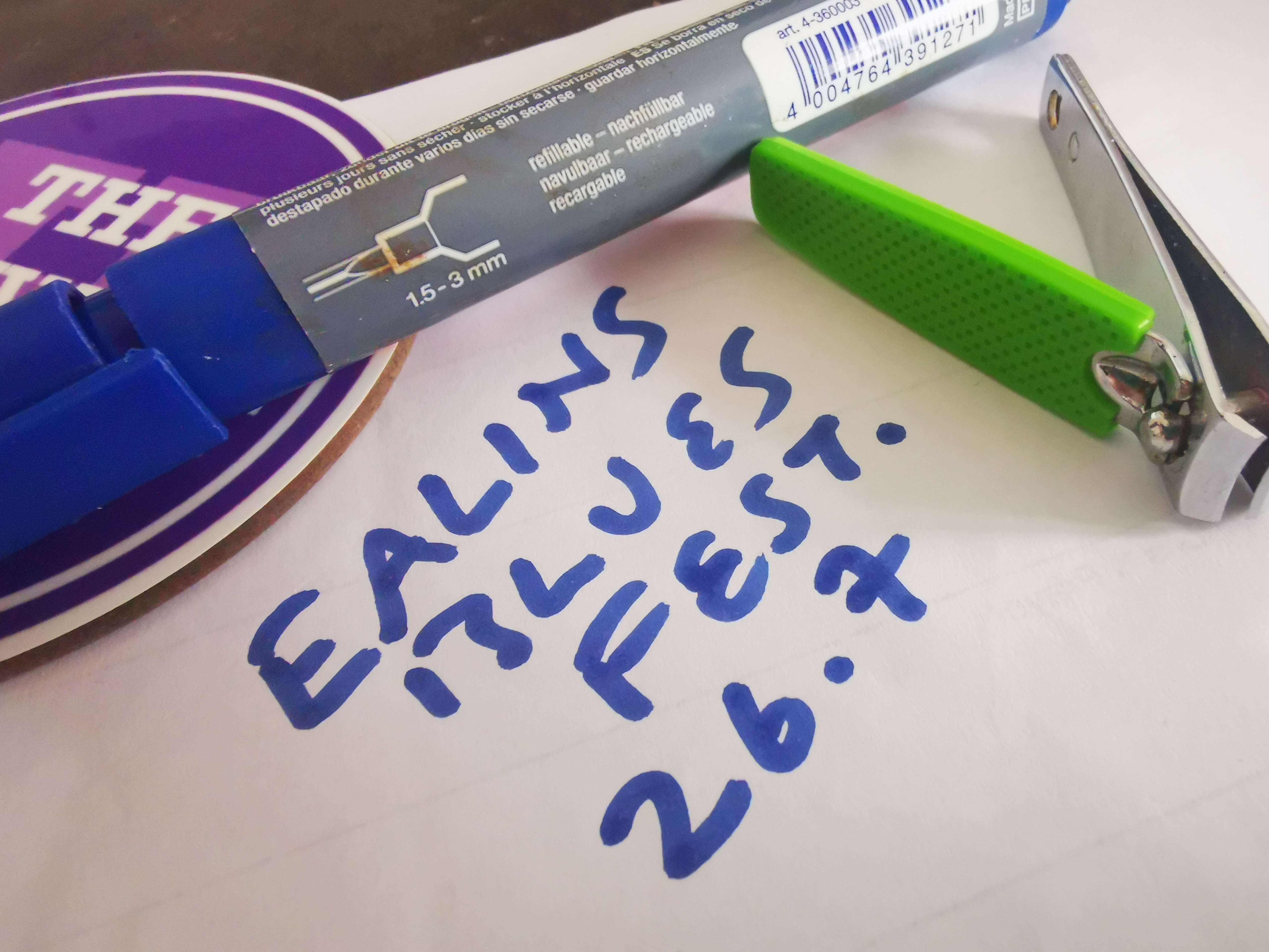 a pen, a pencil, and a marker on top of a piece of paper