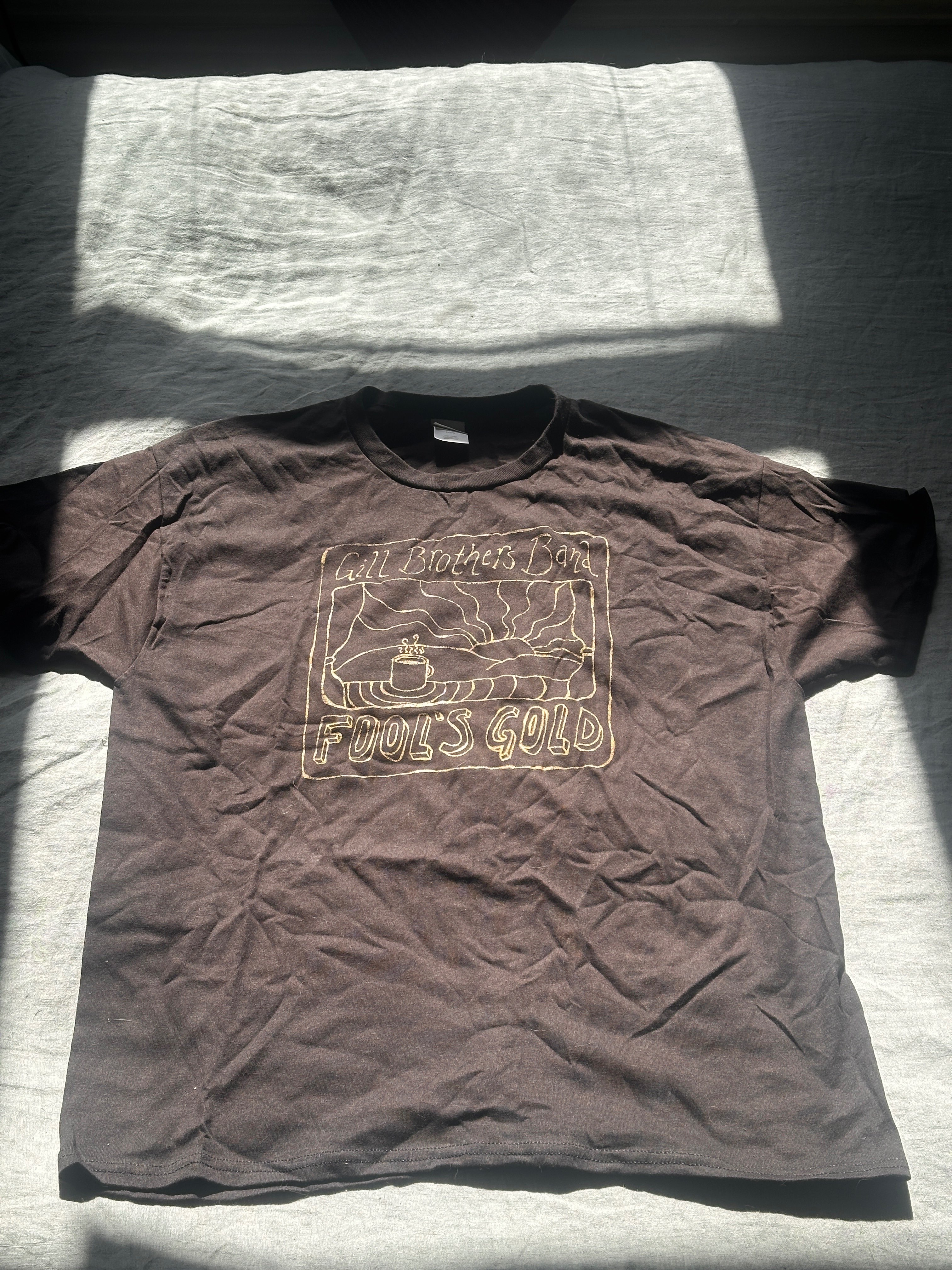a brown t - shirt with an image of a train on it