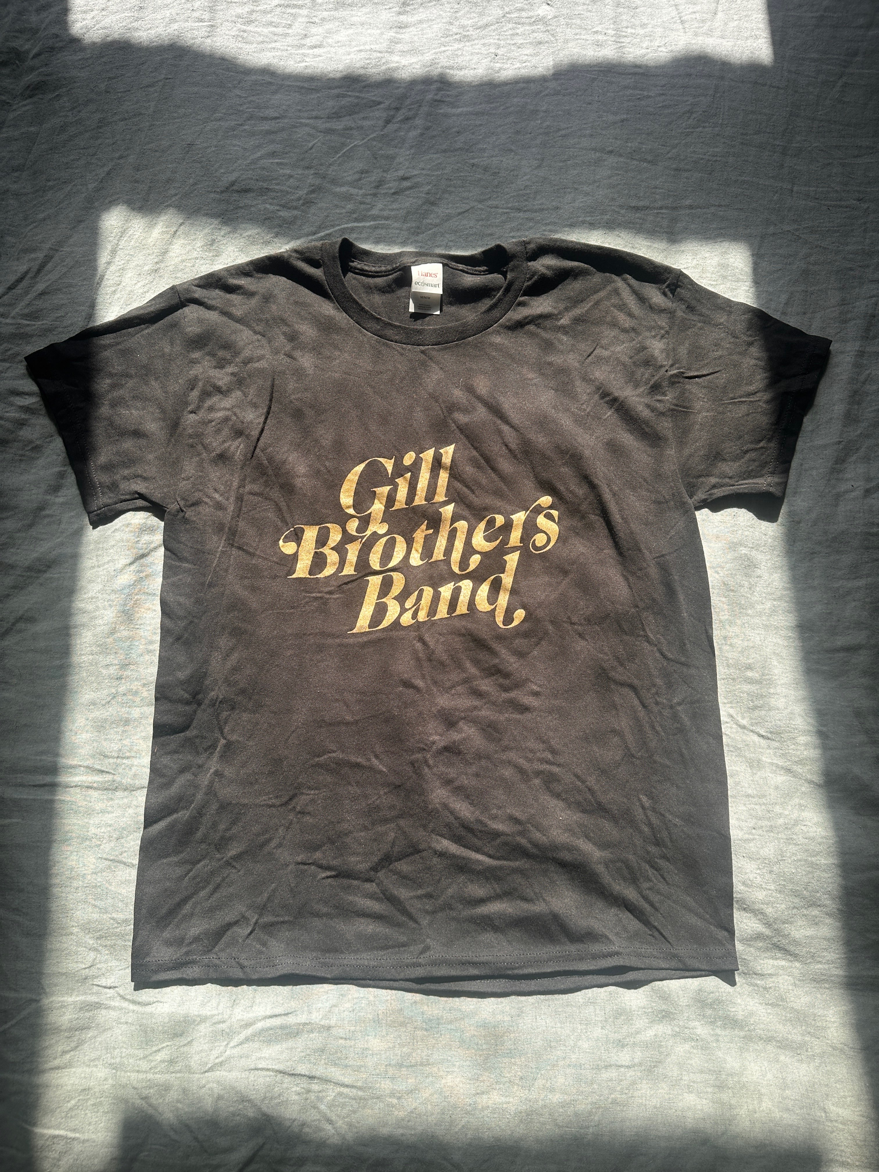 a black t - shirt with the words gil brothers band on it