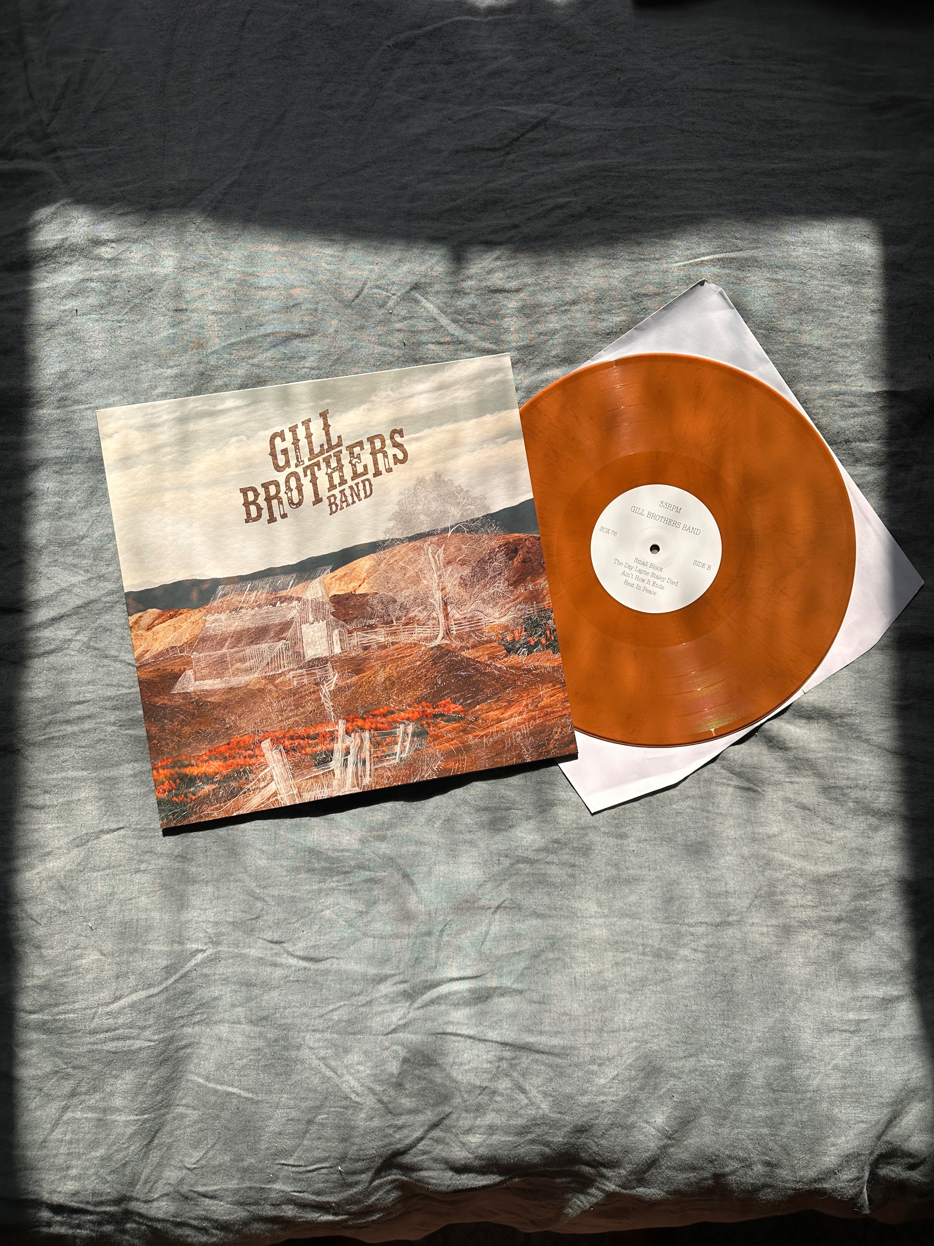 a white cd with an orange cover on a bed