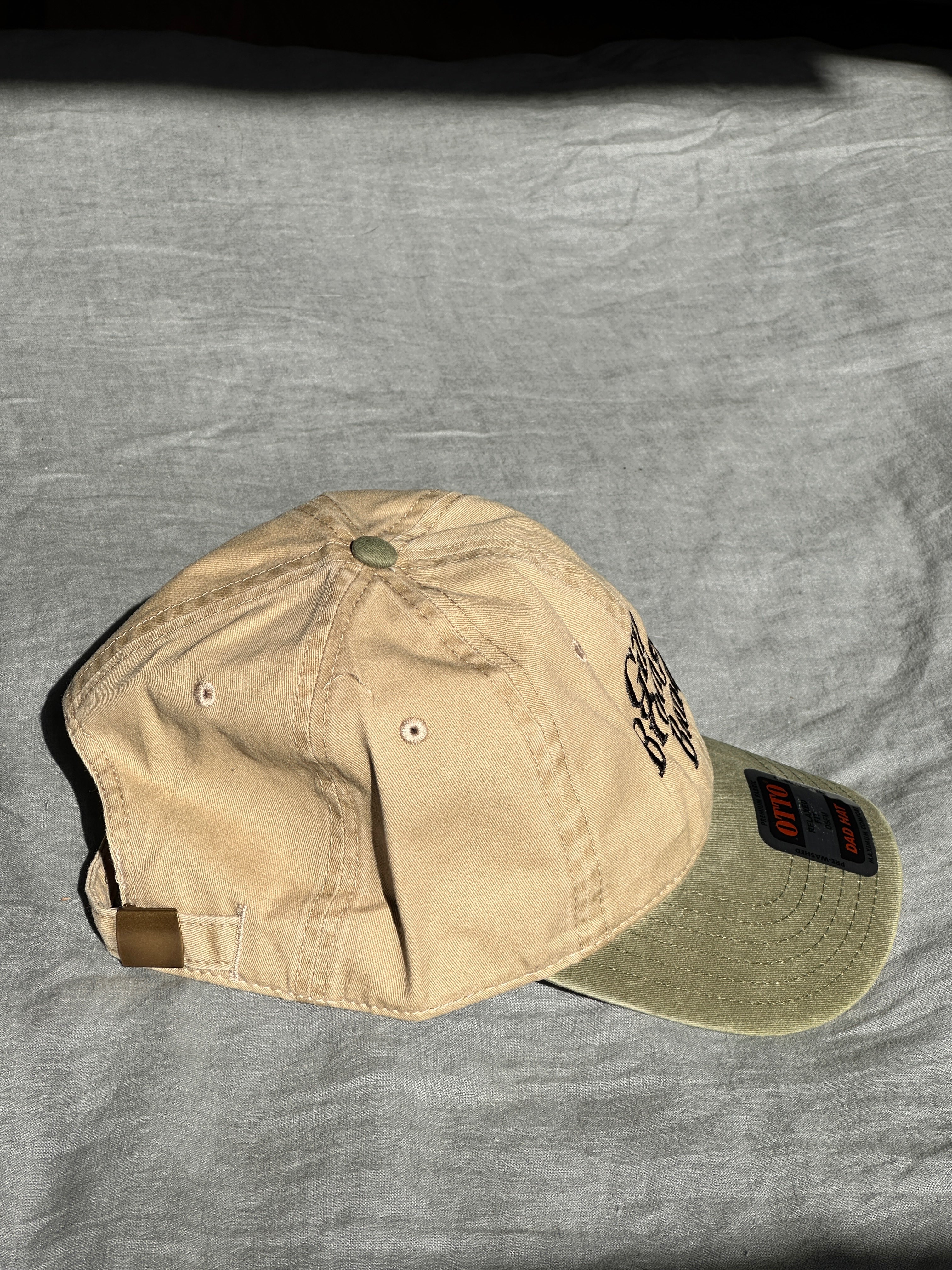 a tan hat with a logo on it
