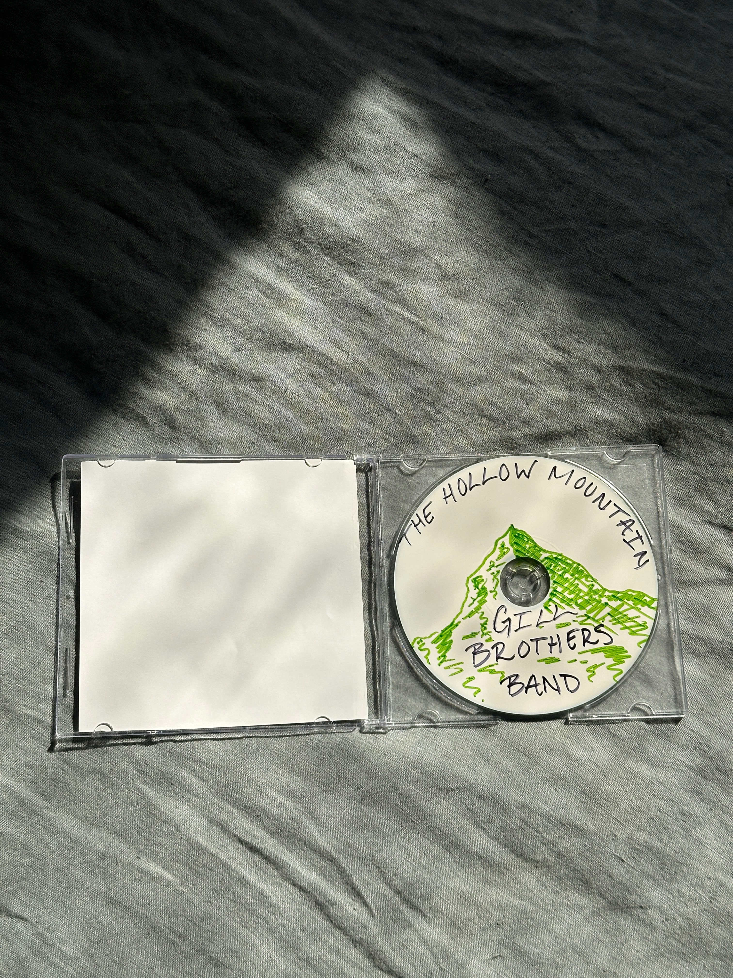 a cd with a green cover on it