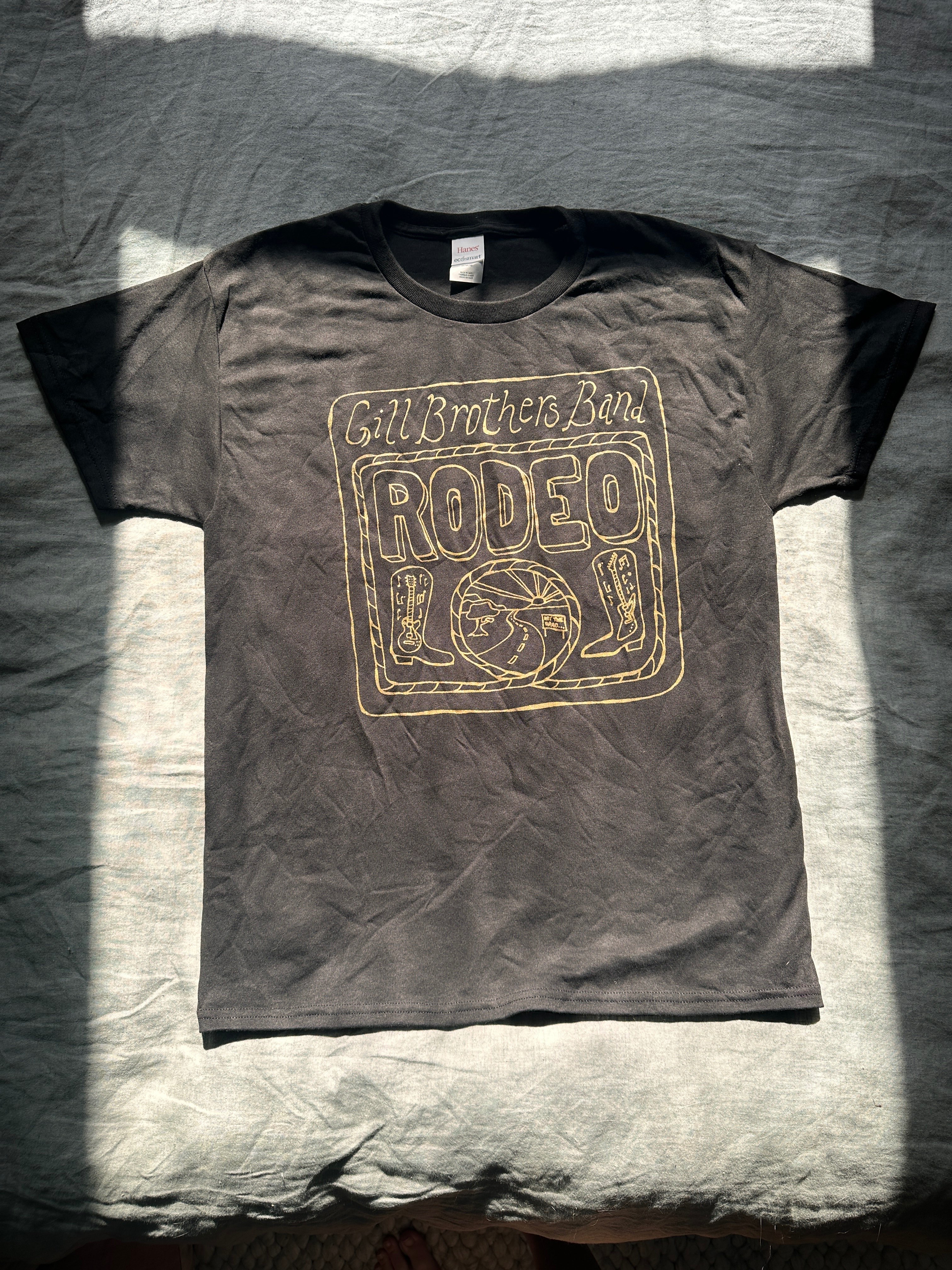 a black t - shirt with the word rodeo on it