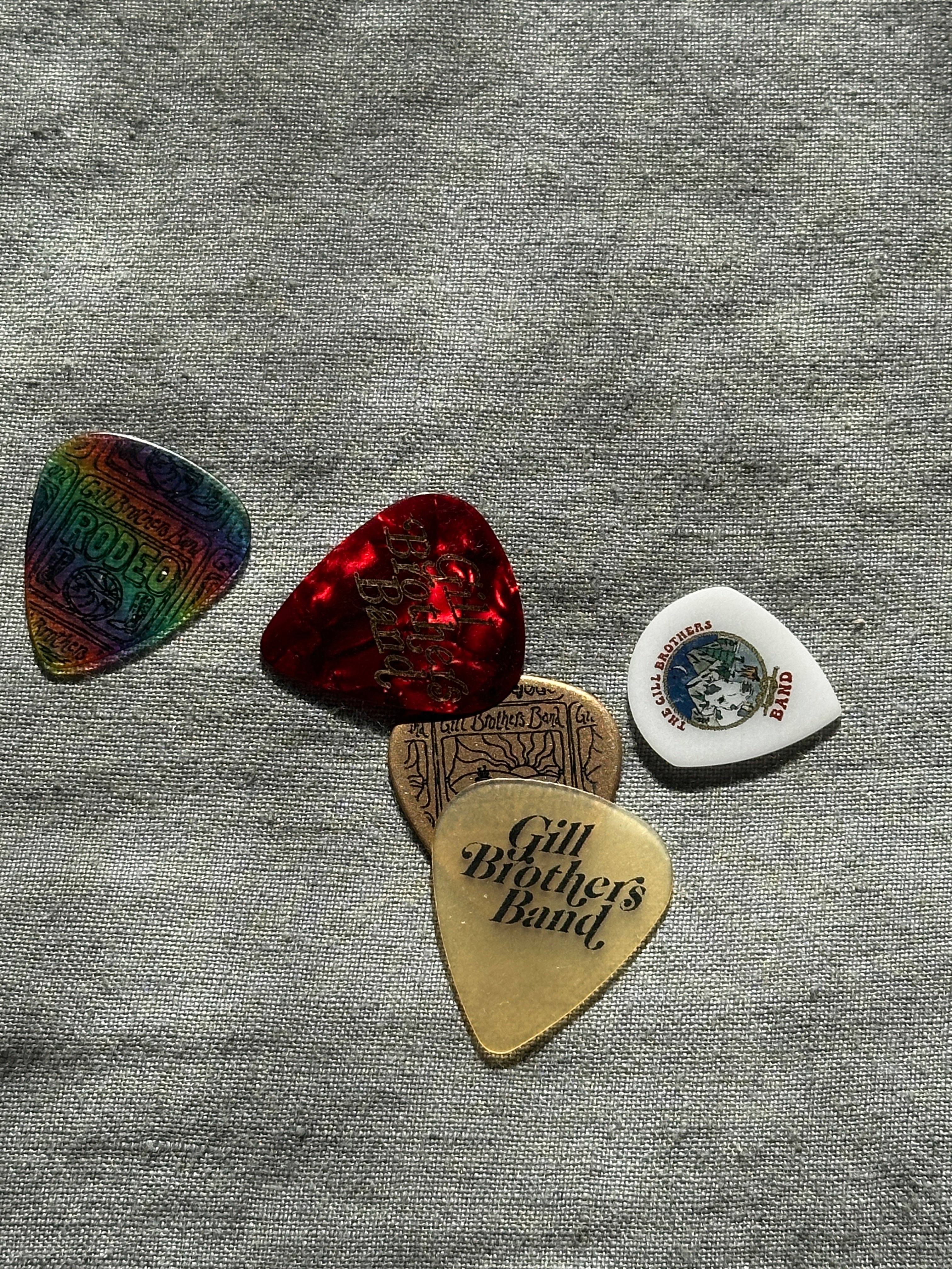 a group of guitar picks on a gray surface