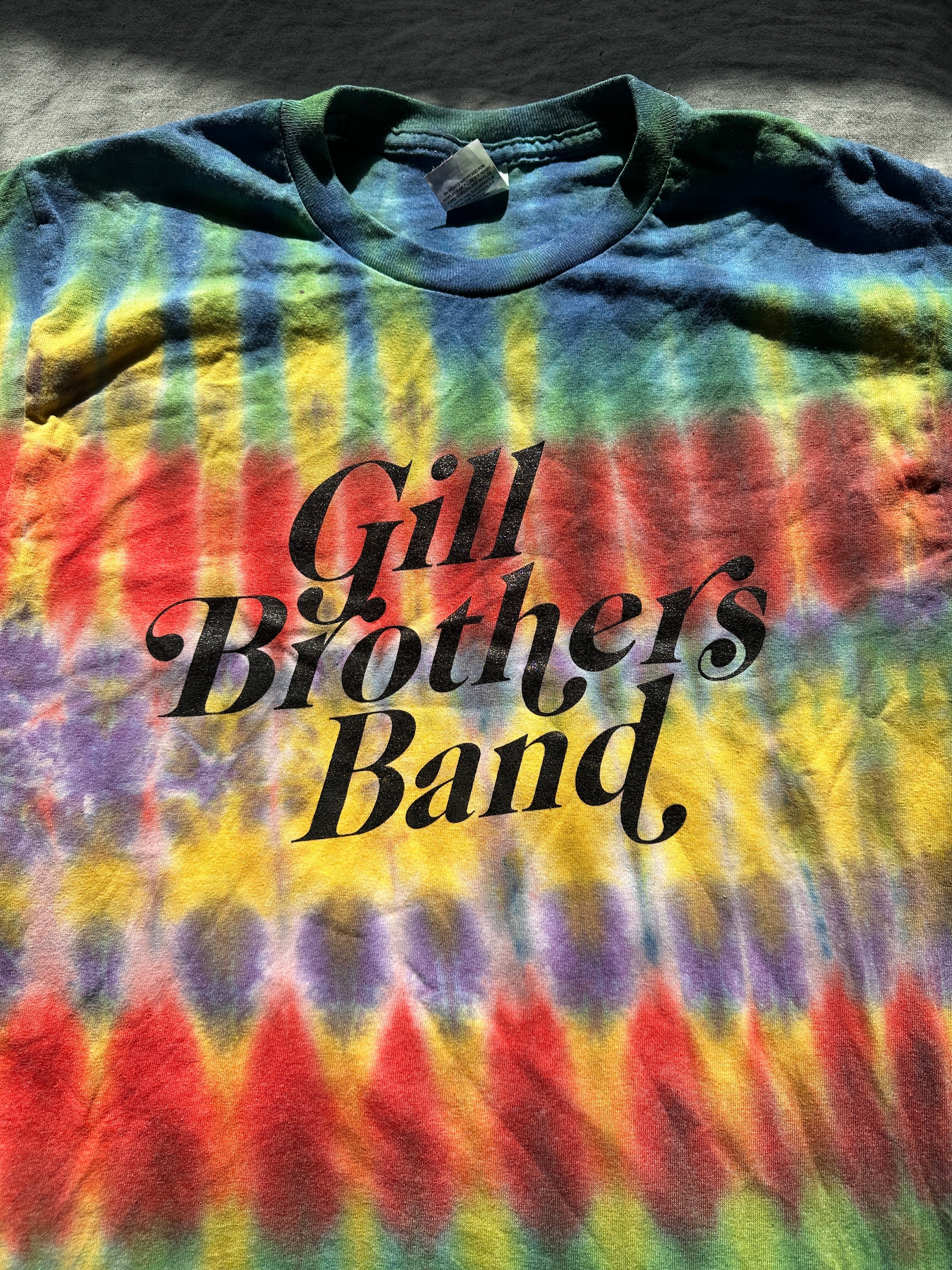 a tie dye t - shirt that says gill brothers band