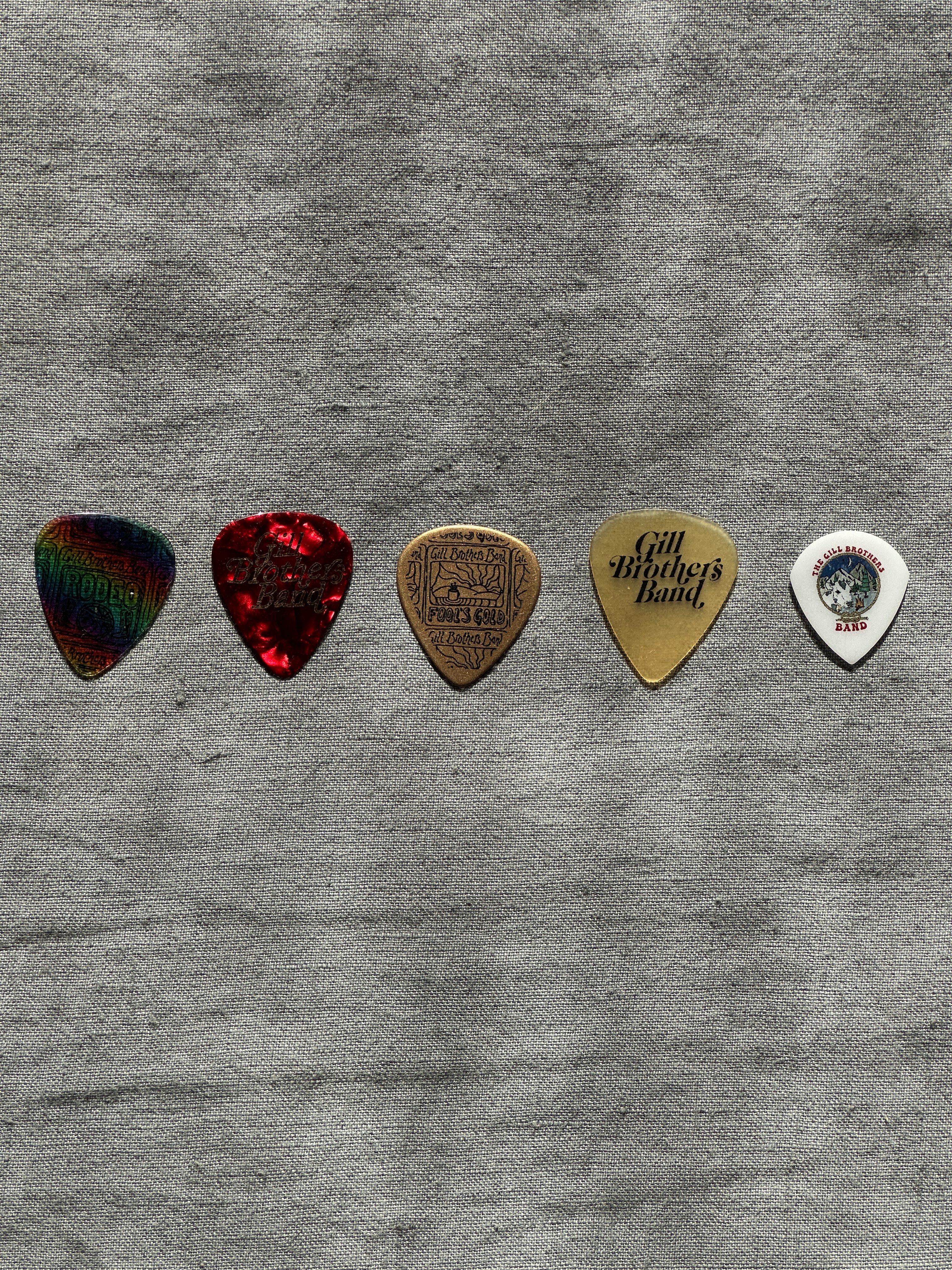 a group of guitar picks on a grey surface