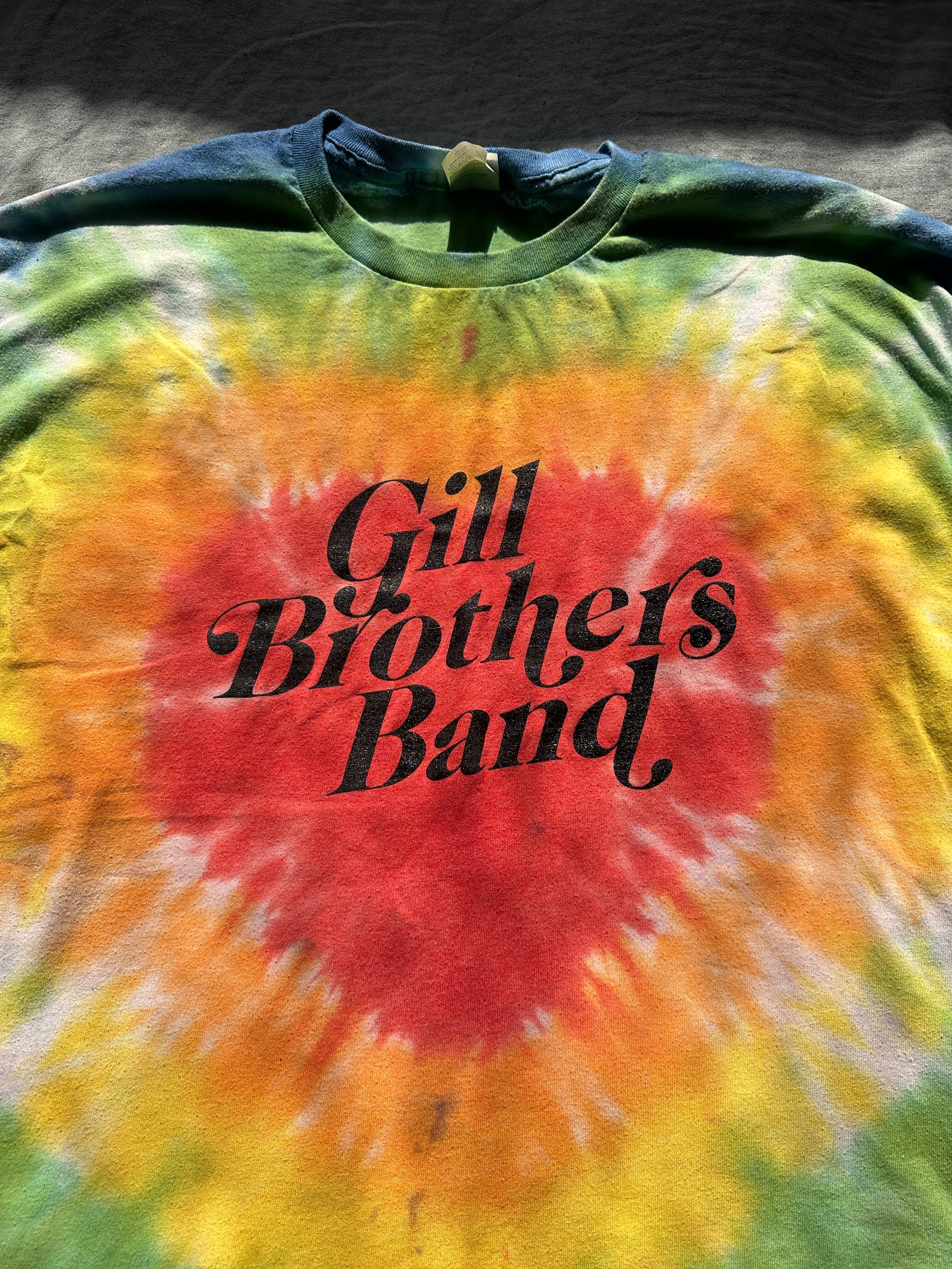 a tie dye t - shirt that says gill brothers band
