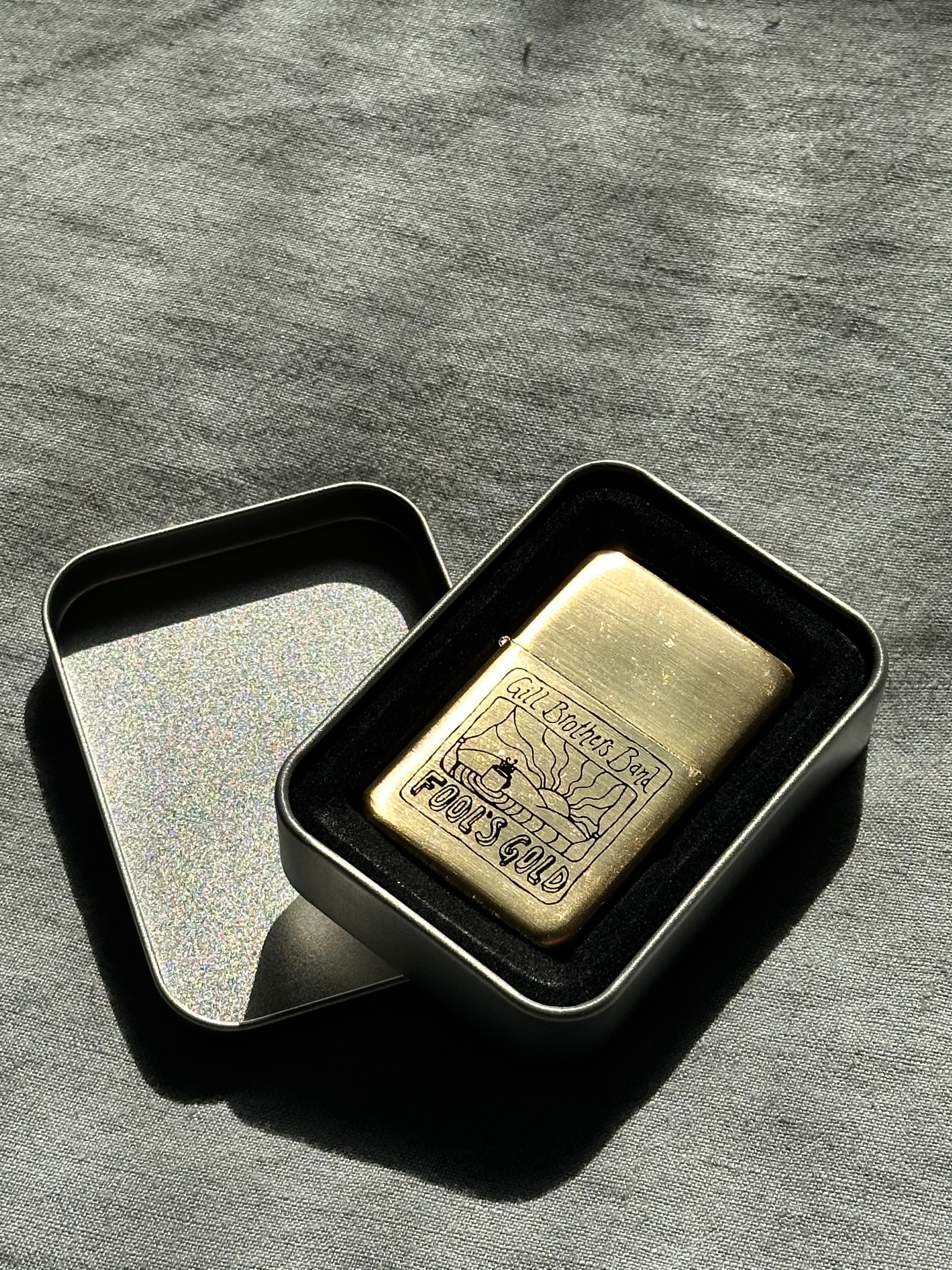 a gold bar in a tin on a table
