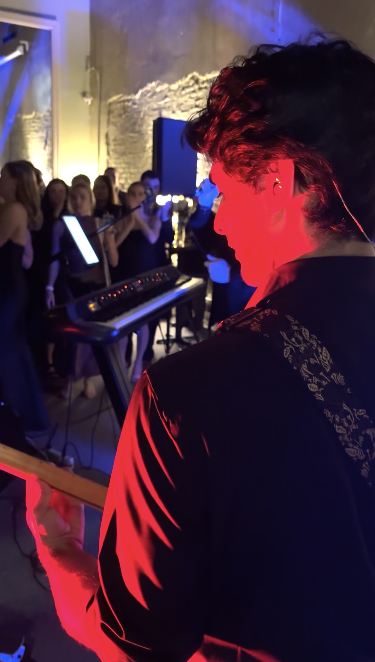 a man playing a guitar in front of a crowd