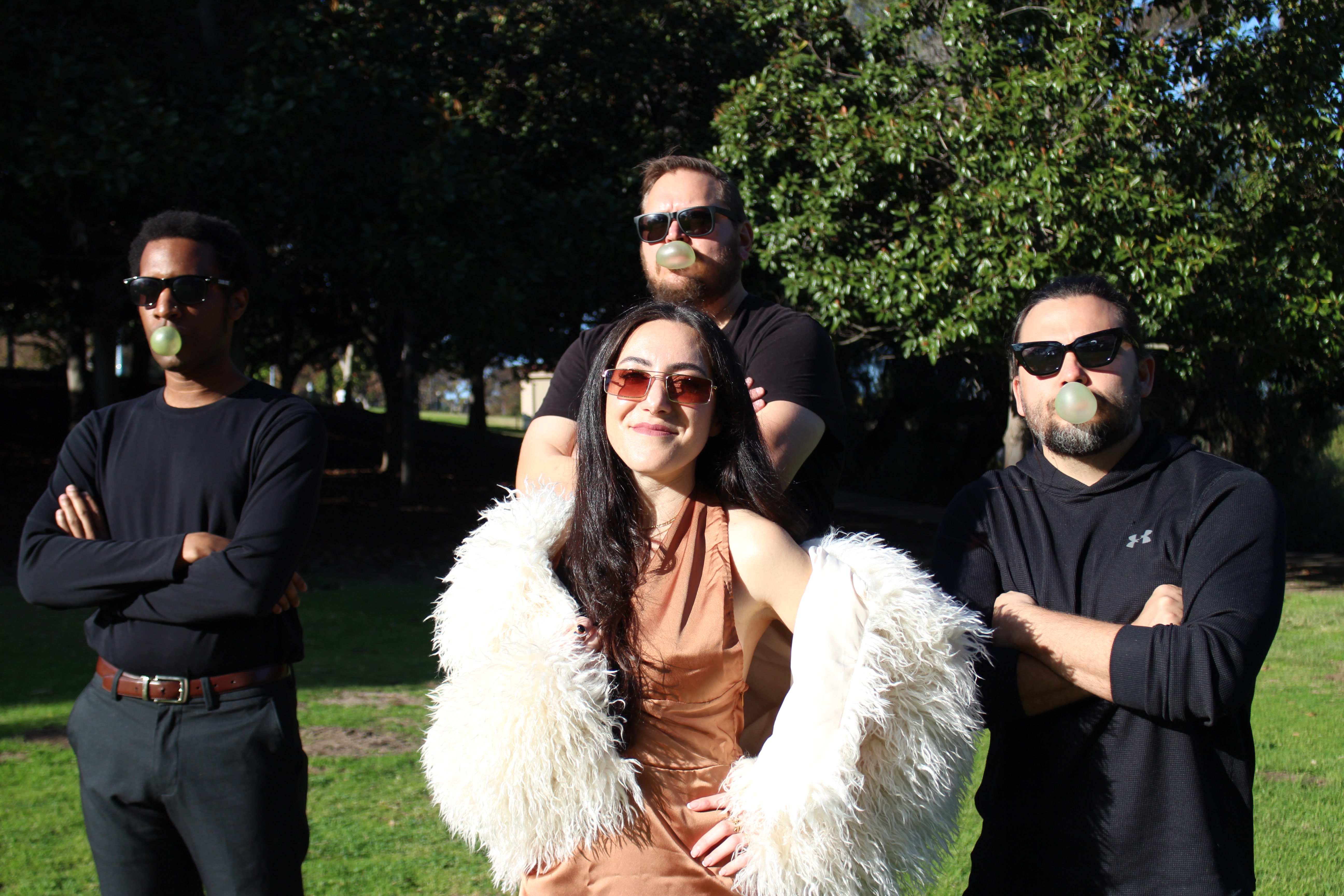 a group of people posing for a picture in a park