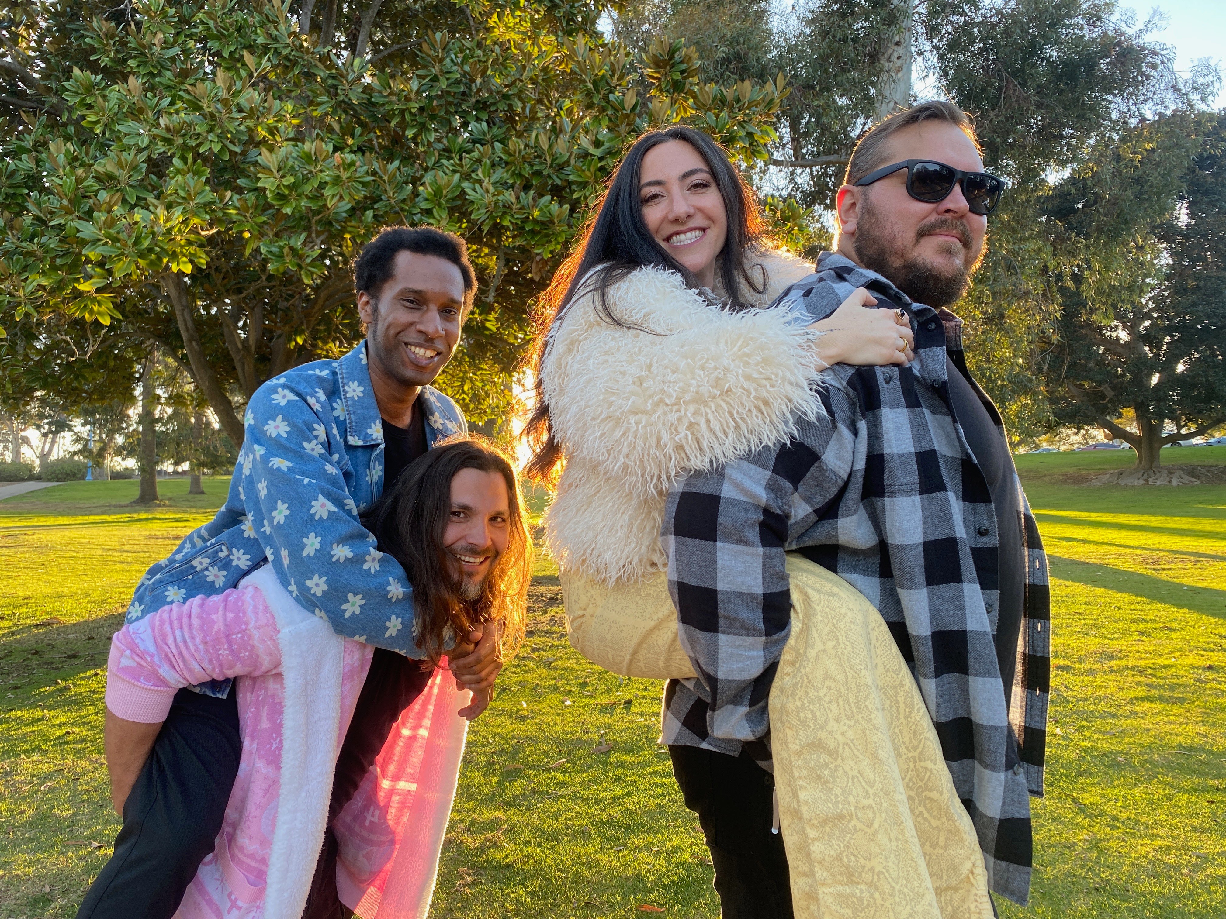 a group of people posing for a picture in a park