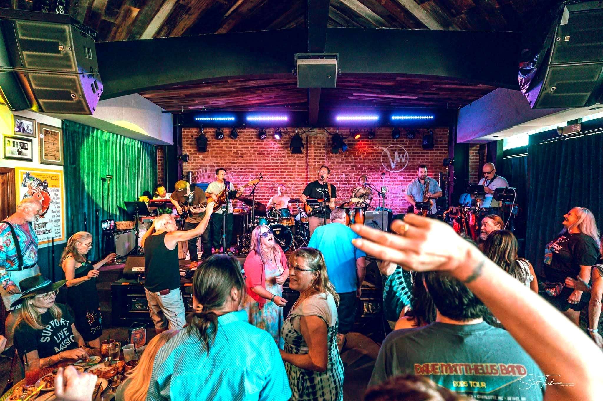 a group of people in a room with a band