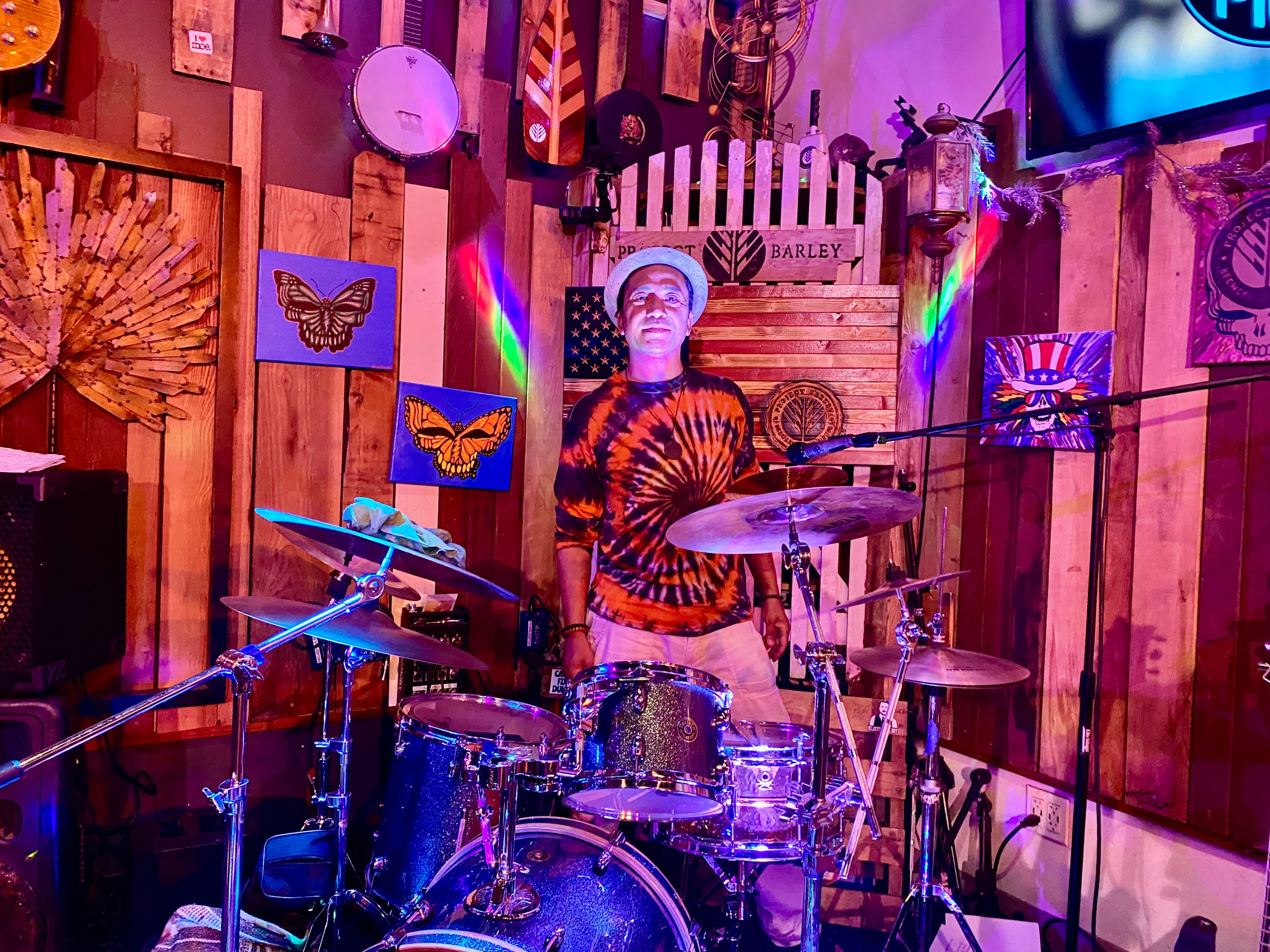a man playing drums in a bar