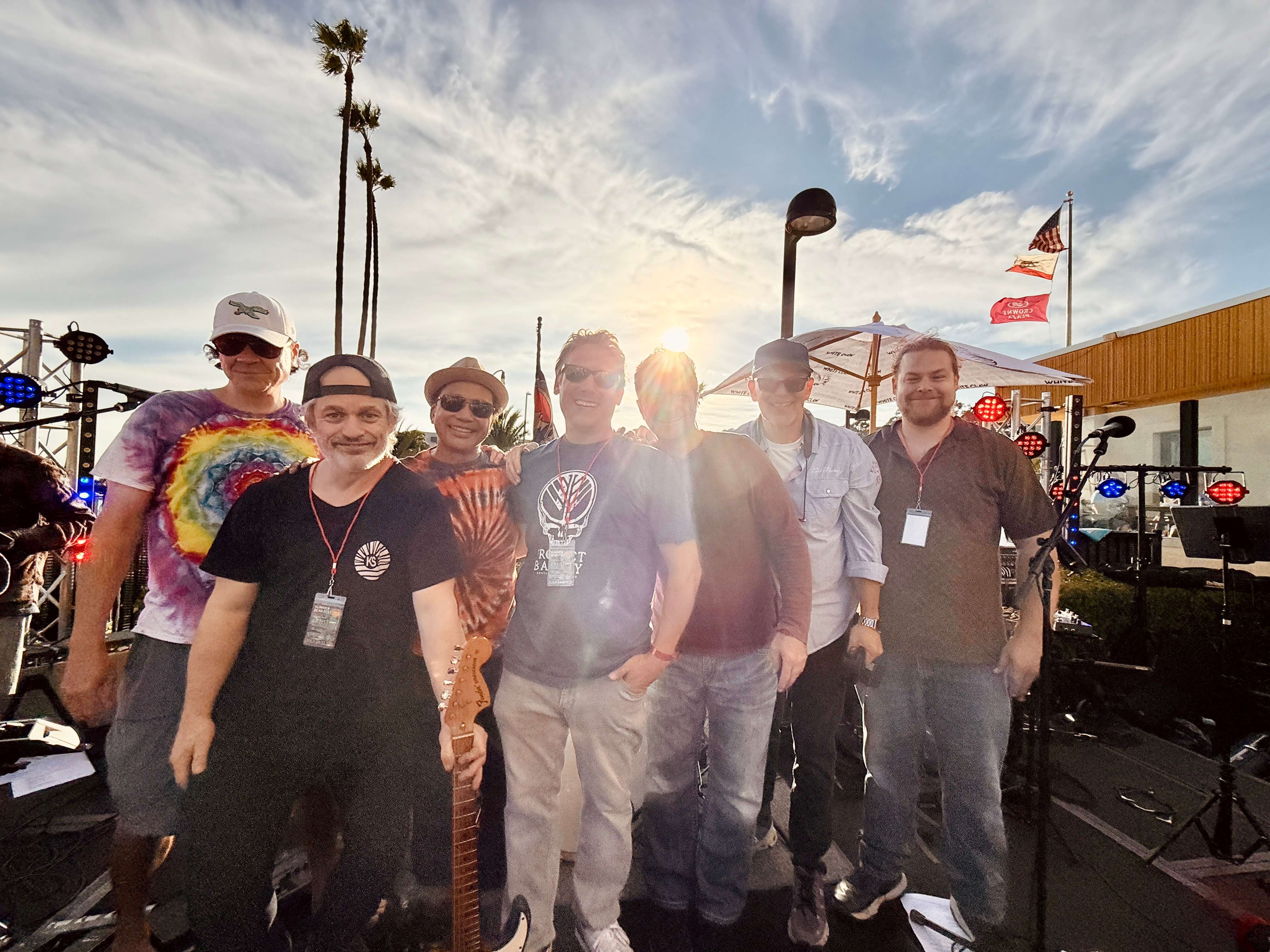 a group of people posing for a picture in front of a flag