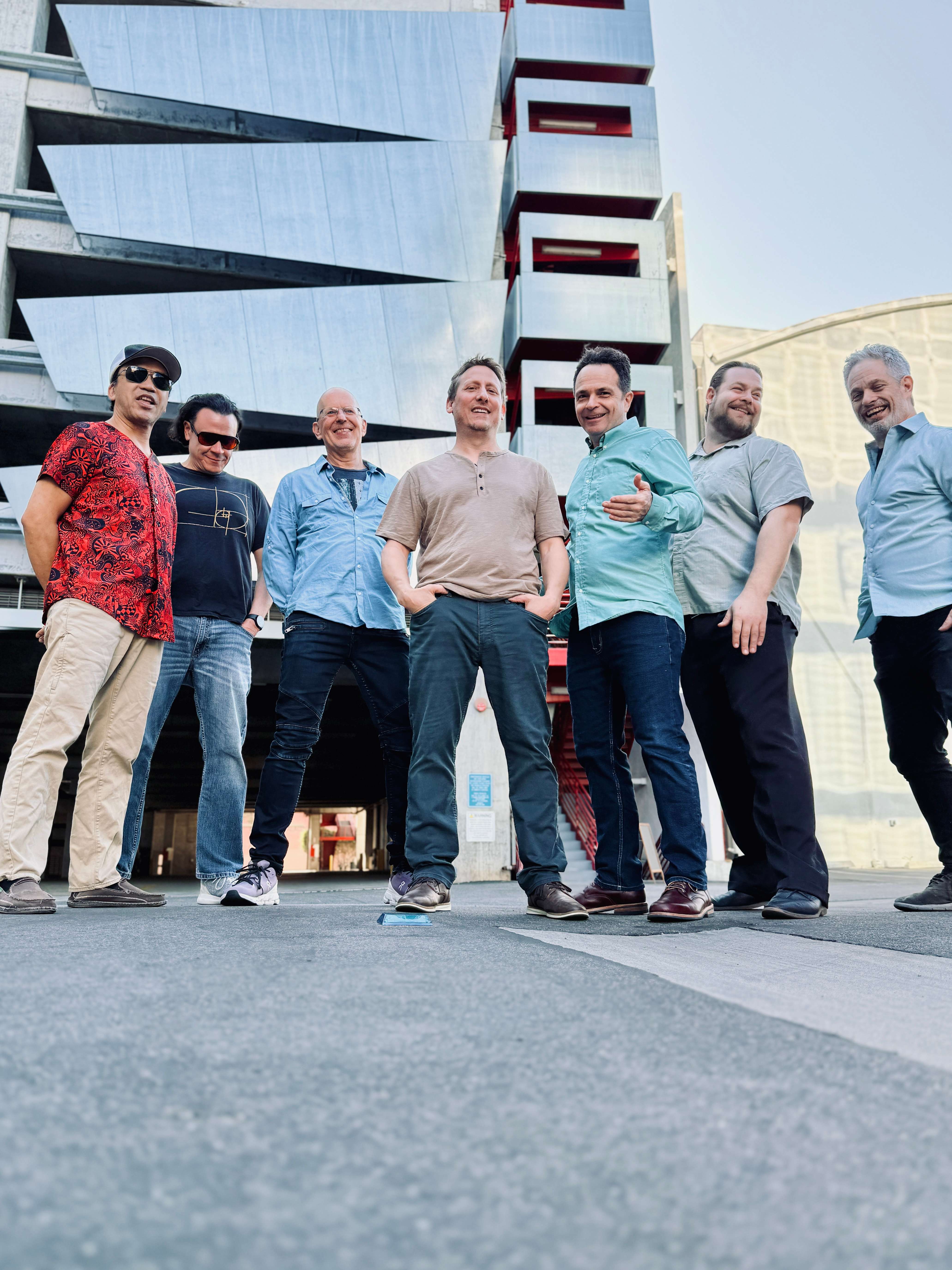 a group of men standing in front of a building