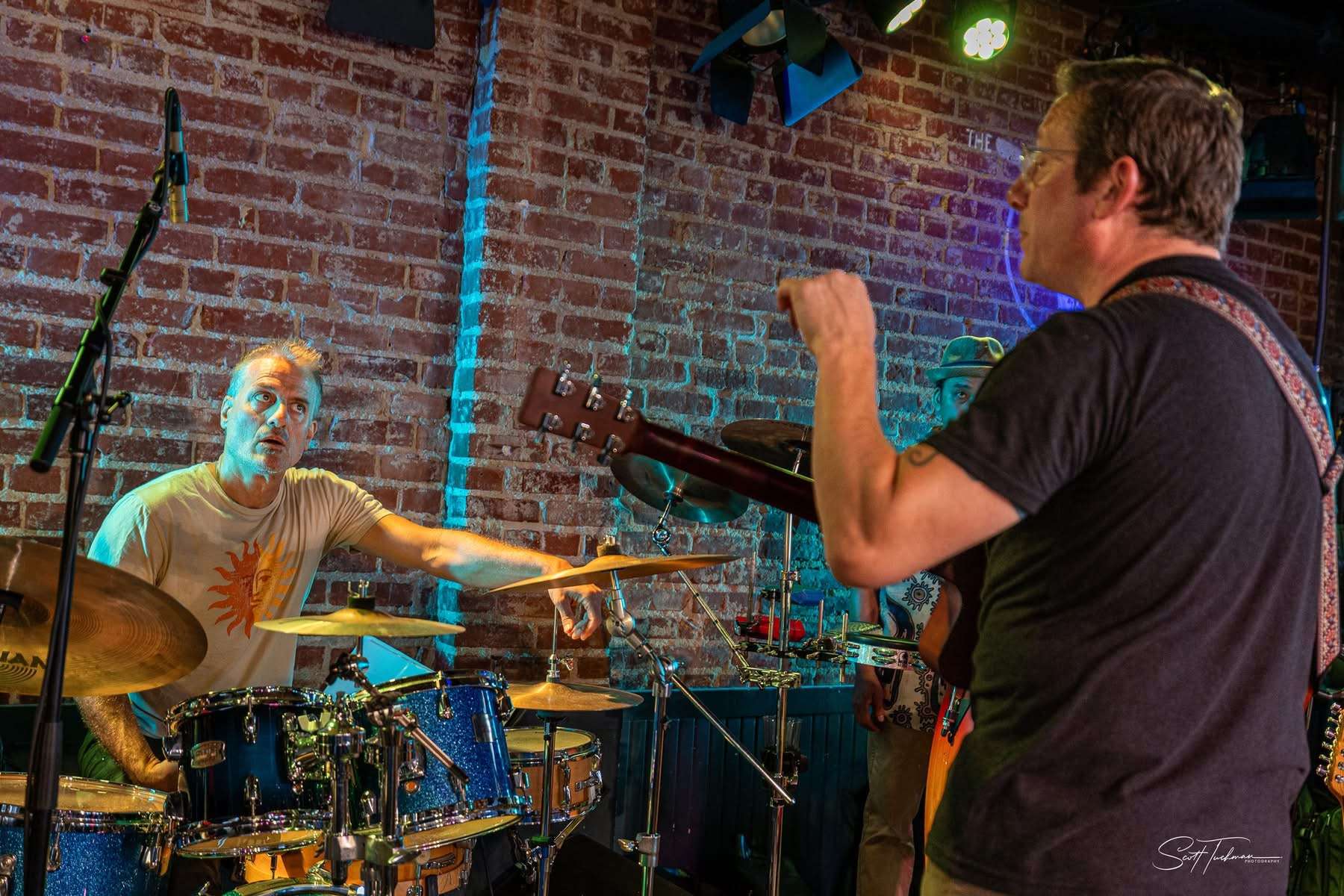 two men playing a musical instrument on stage